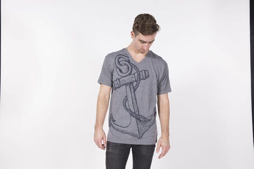 man wearing a gray shirt in a photoshoot man wearing a gray shirt in a photoshoot