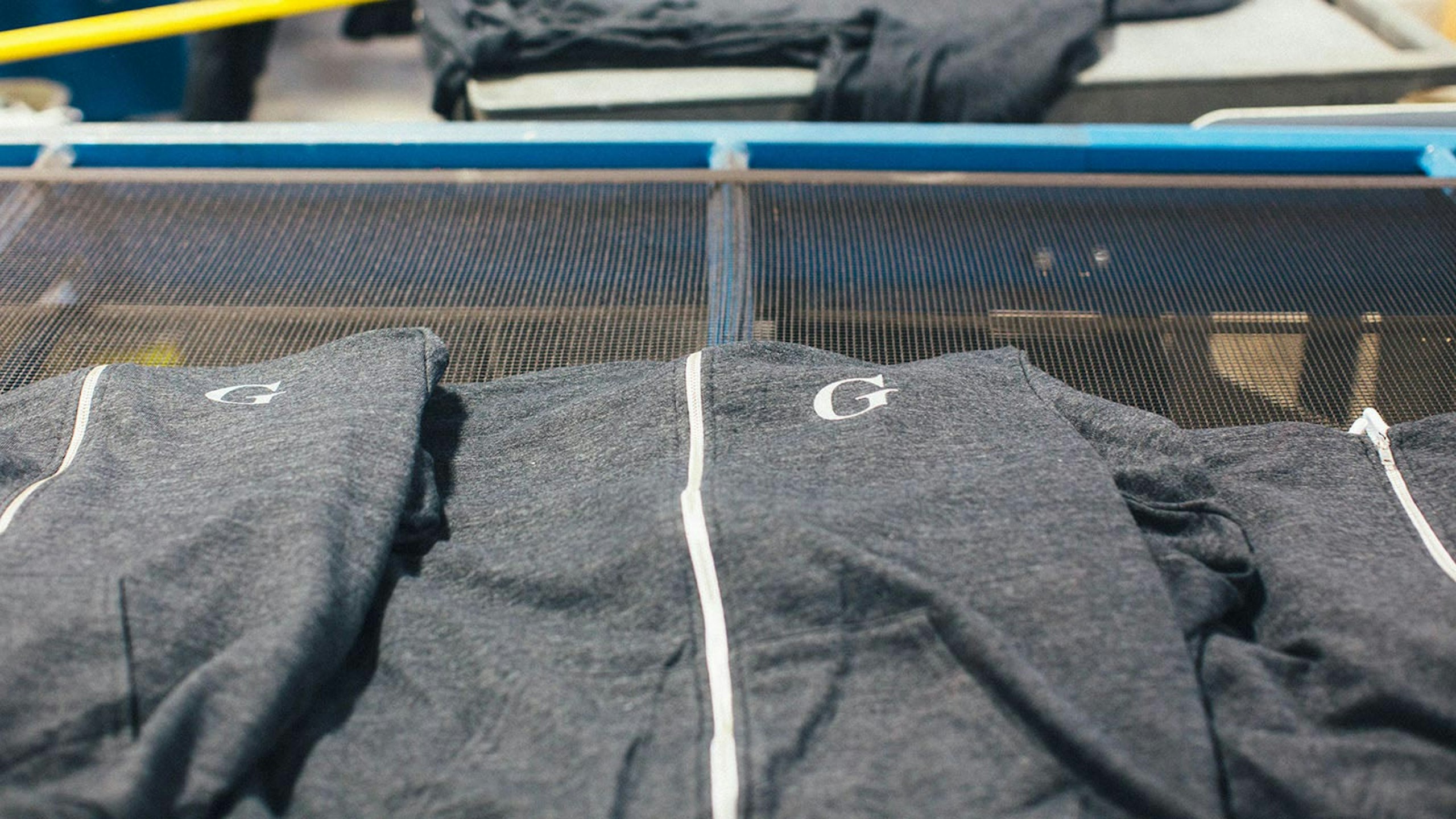 gray zip-up hoodies stacked