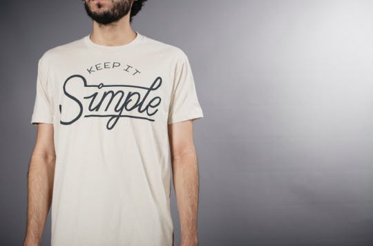 man wearing white shirt with text on front man wearing white shirt with text on front