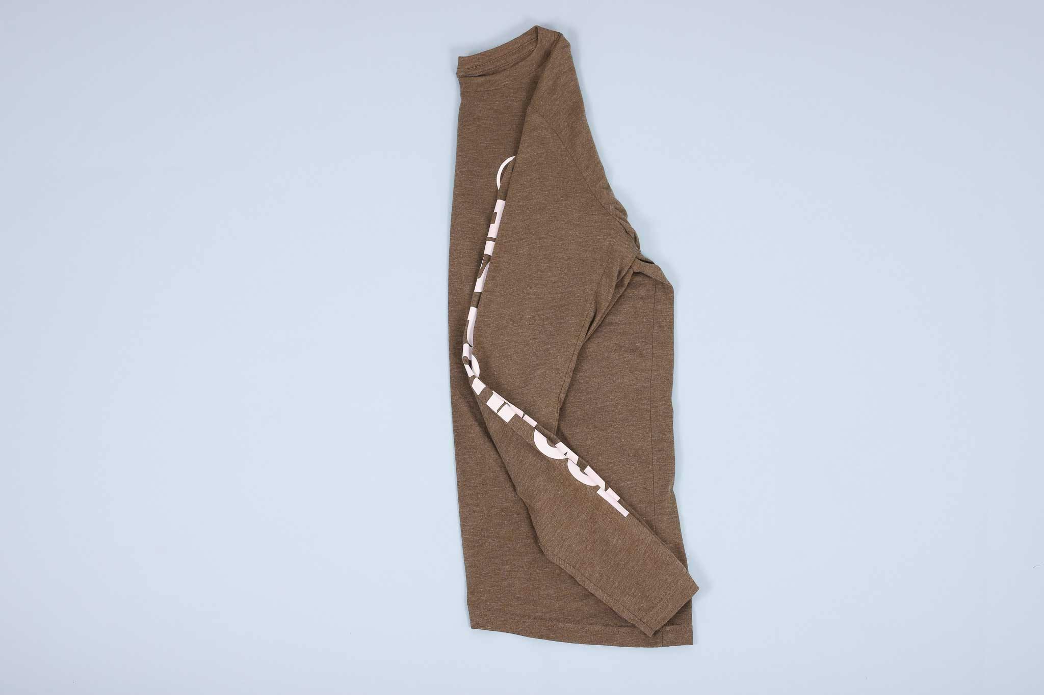 Olive long sleeve t-shirt folded in half with sleeve folded into the shirt Olive long sleeve t-shirt folded in half with sleeve folded into the shirt
