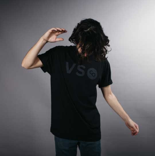 man with long hair modeling a black on black shirt man with long hair modeling a black on black shirt