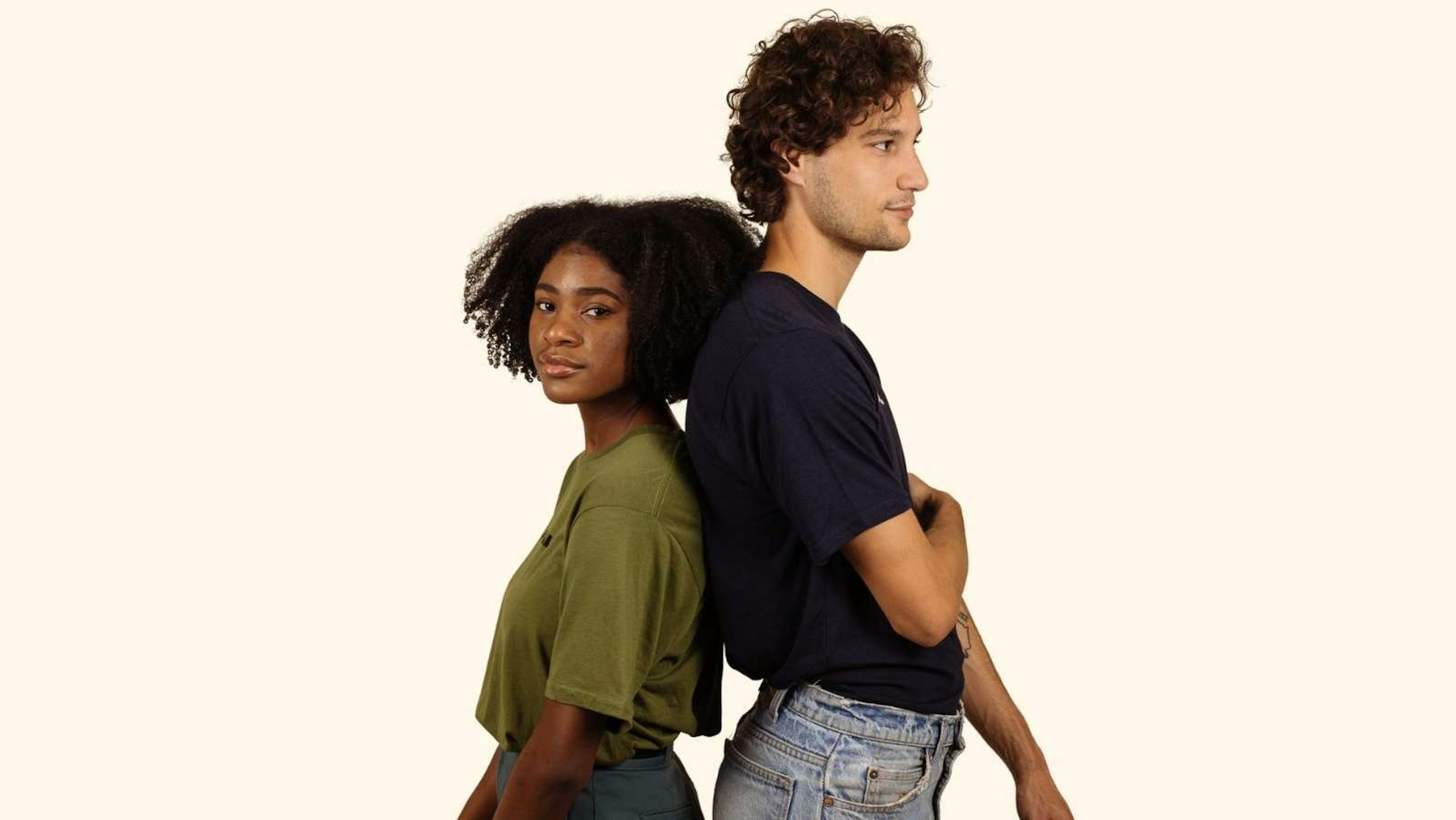 women wearing a olive green shirt back to back with a man wearing a black shirt
