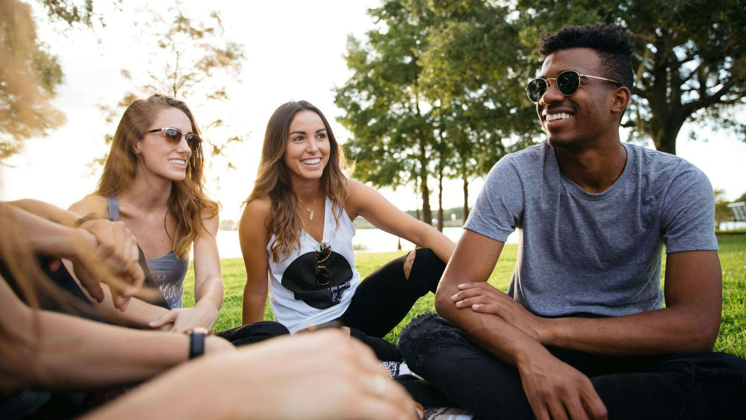 group of people sitting in a park