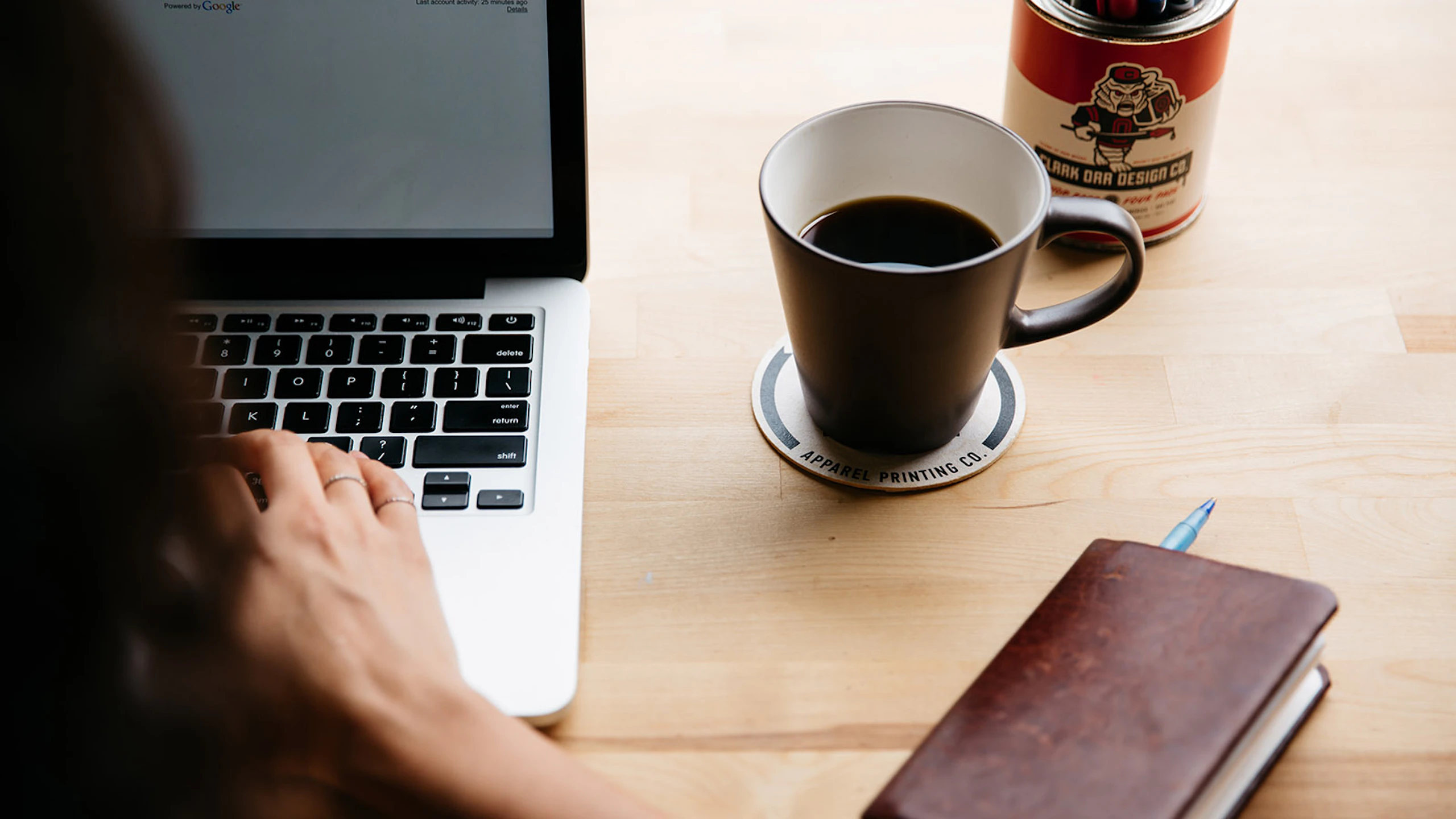 person at a laptop with coffee mug