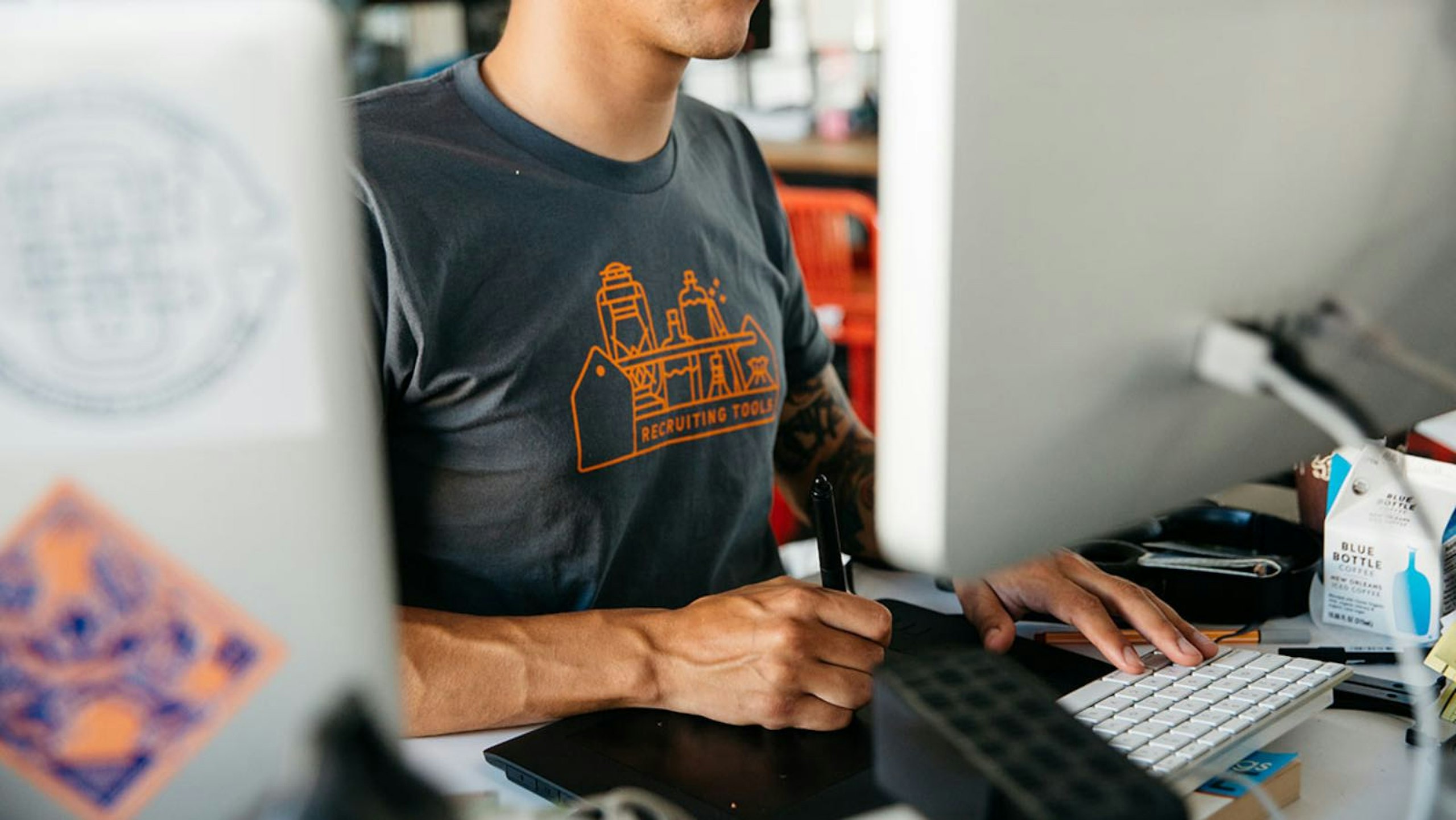 person standing at a computer checking orders
