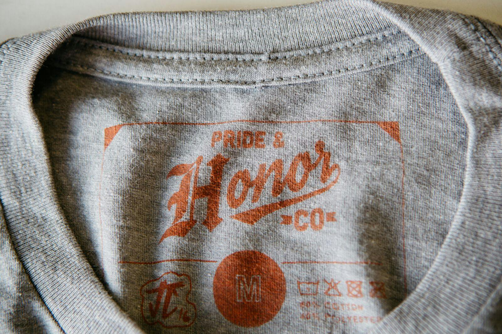gray shirt with a close up of a square printed tag gray shirt with a close up of a square printed tag