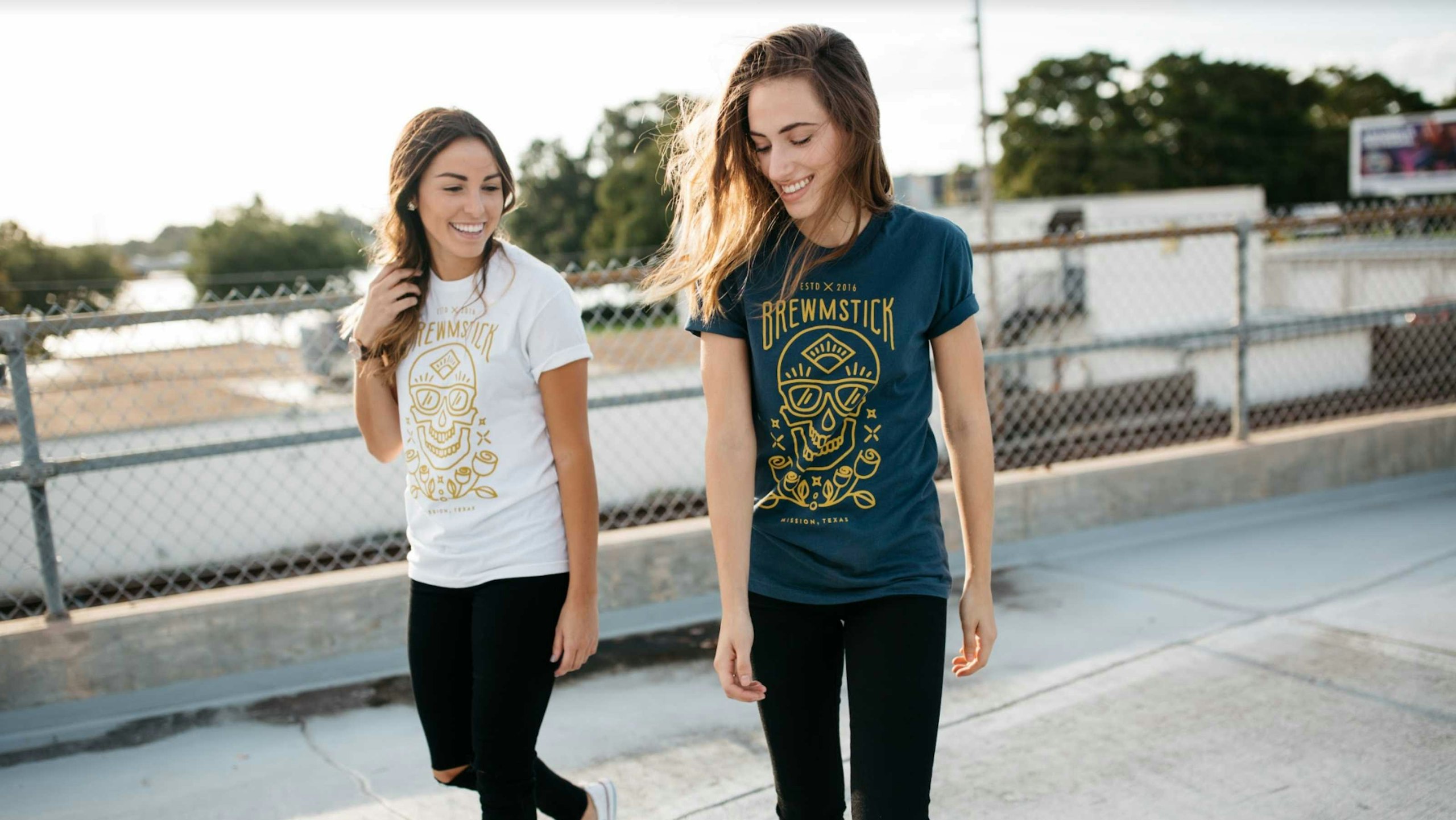two women, one wearing a white shirt and the other a navy shirt