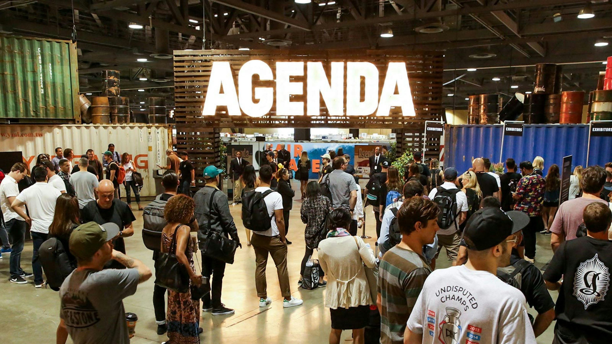 large room of people with the word Agenda large in the center