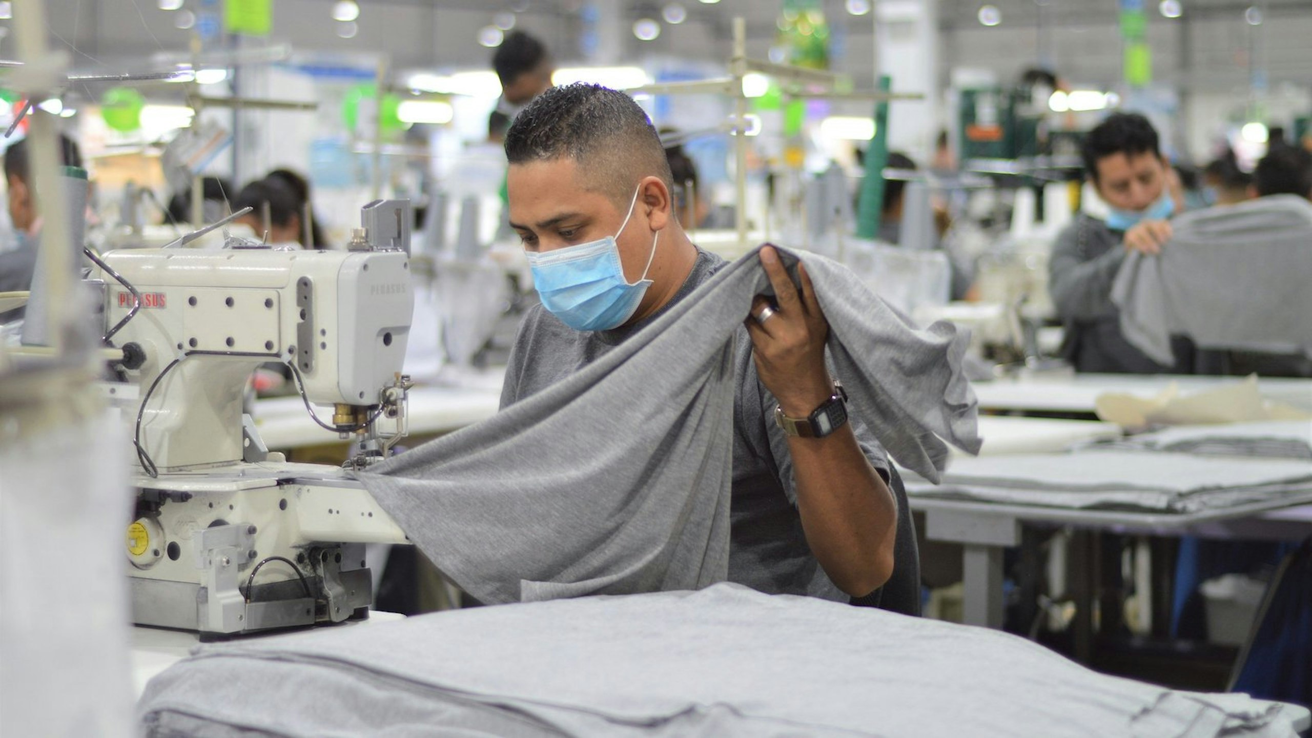 person sewing a t-shirt