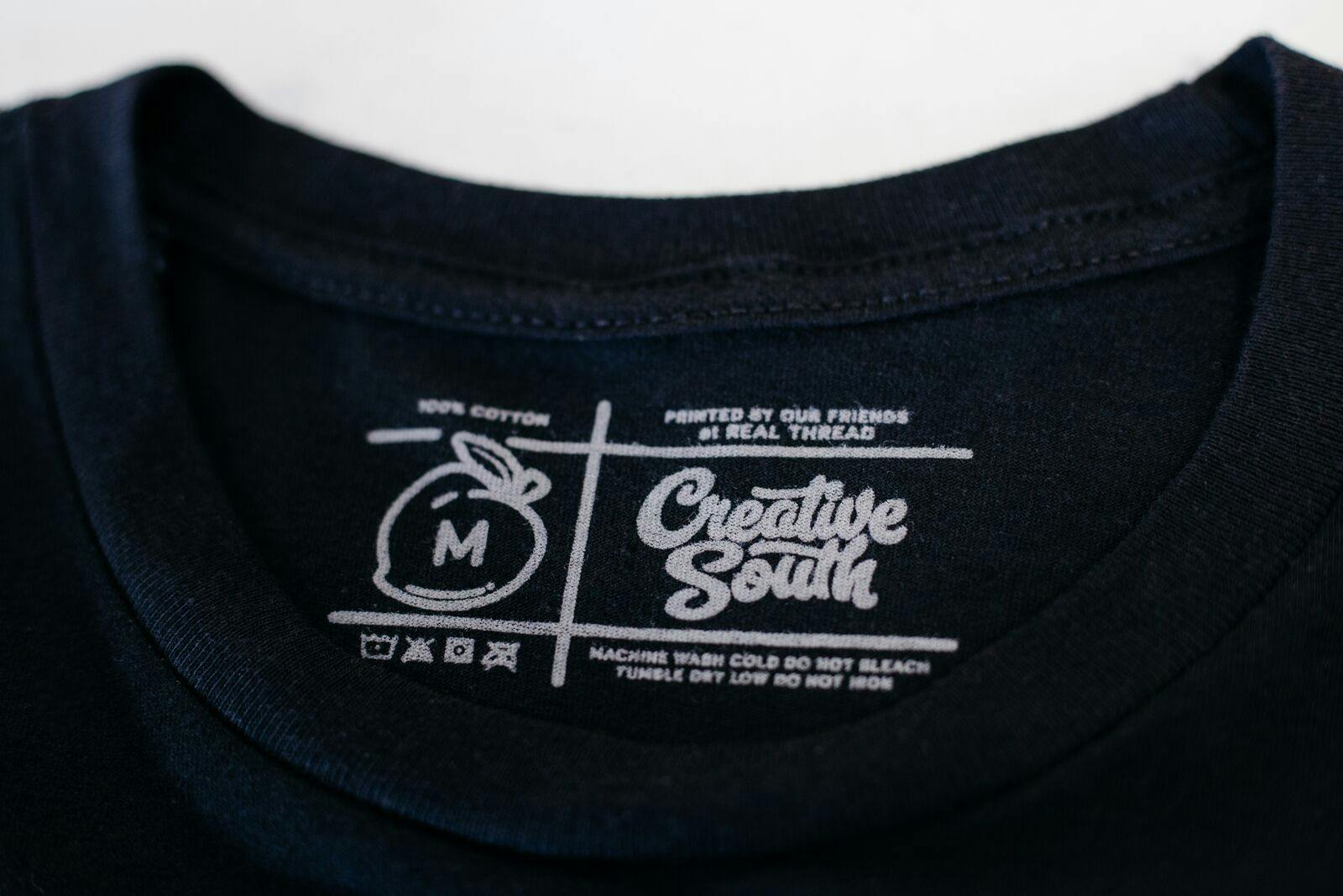 black shirt with a close up of a printed tag black shirt with a close up of a printed tag