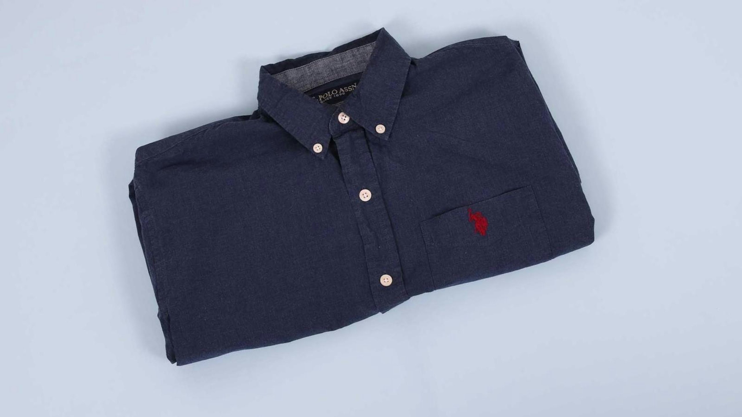 black collar shirt folded in half