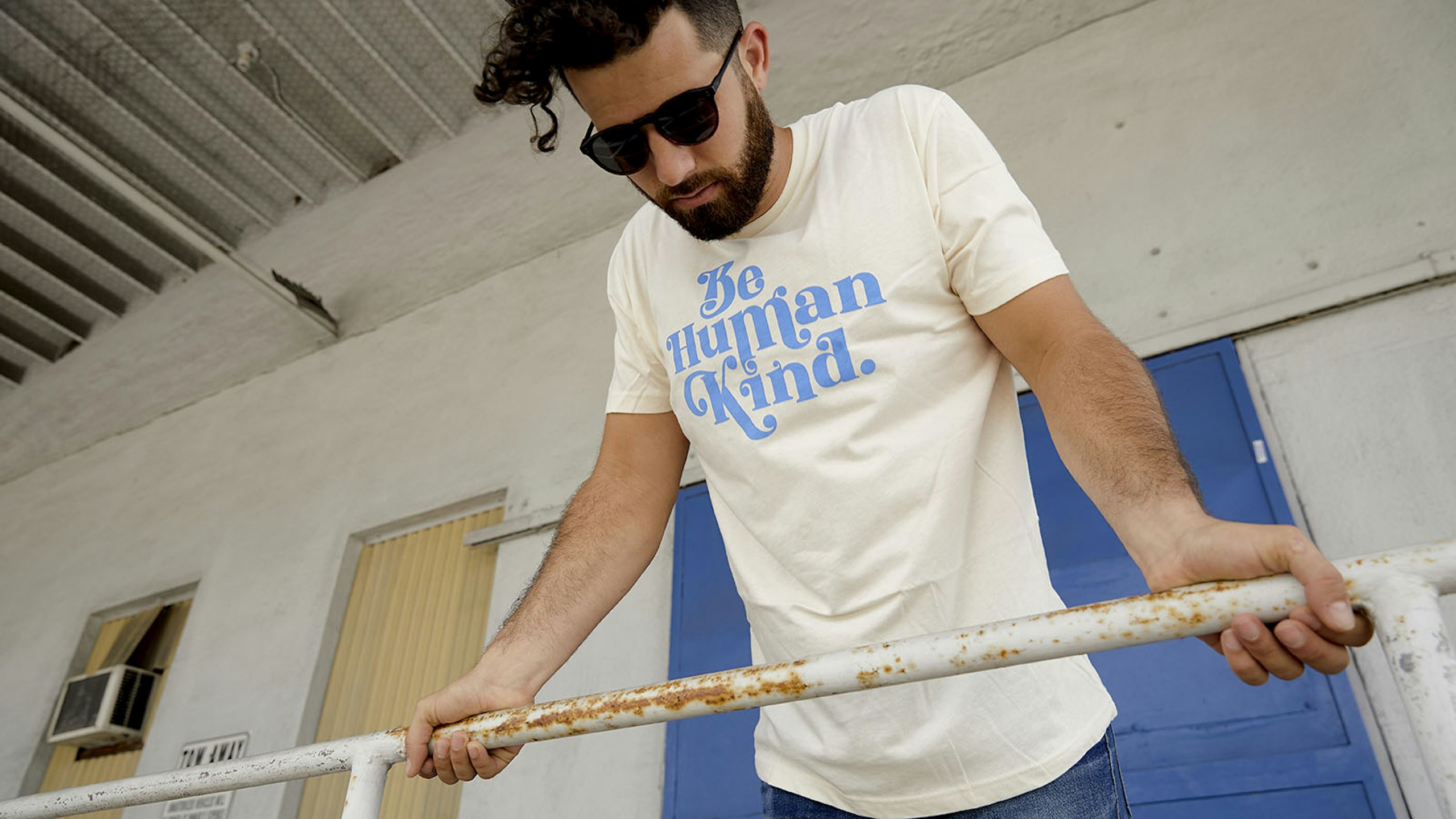 man wearing a white shirt with light blue print