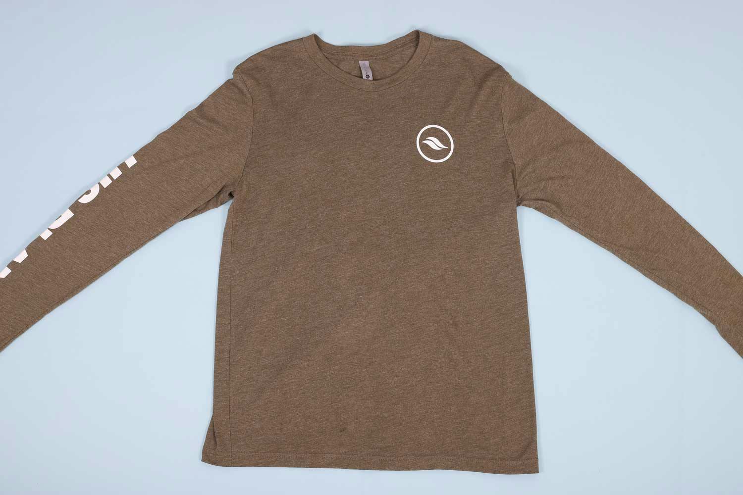 Olive long sleeve t-shirt laying out flat on a light blue background Olive long sleeve t-shirt laying out flat on a light blue background