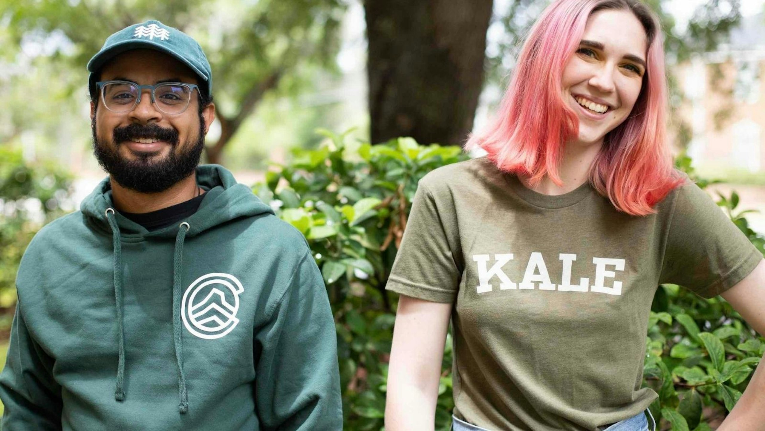man wearing a green hoodie and women wearing a olive green shirt