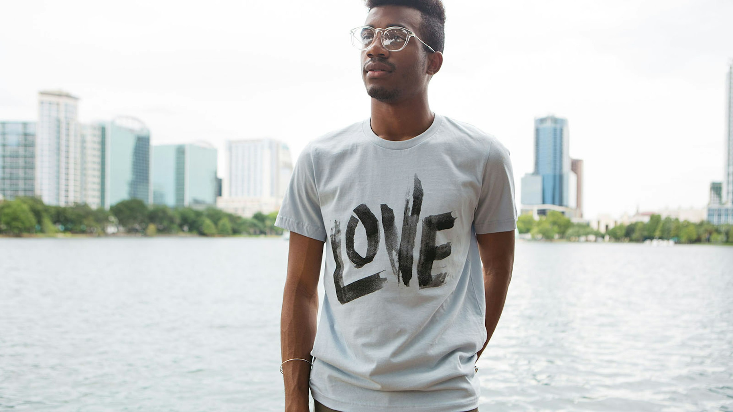 man wearing a off-white shirt with the word love wrote on it