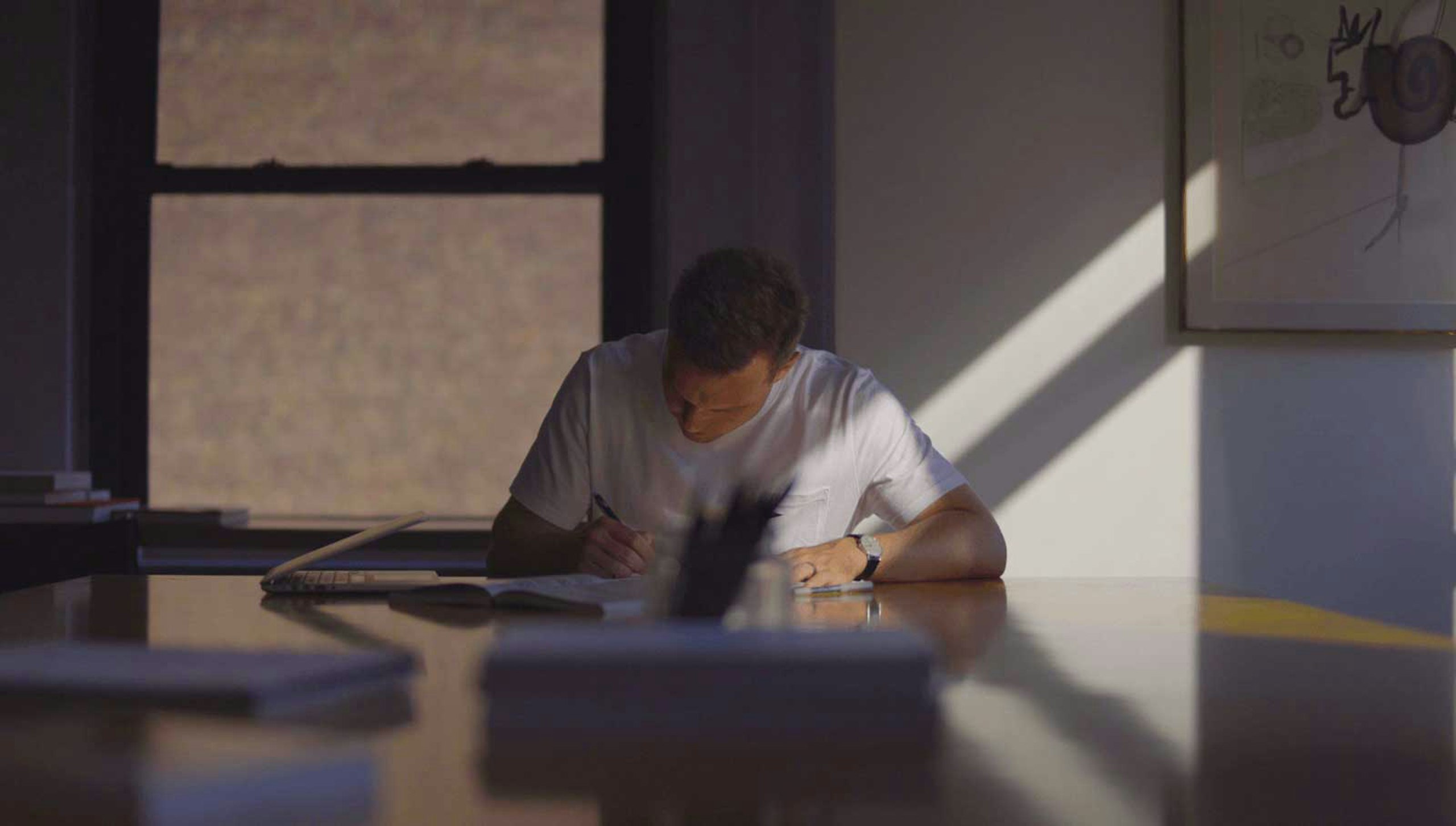 person sitting in the dark at a table