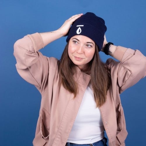 A girl wears a custom embroidered beanie with logo A girl wears a custom embroidered beanie with logo