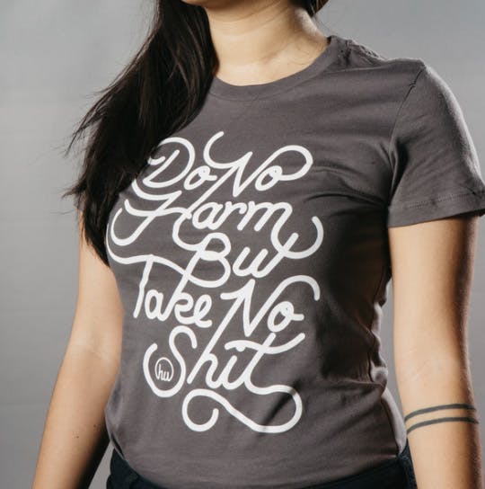 woman wearing shirt with white script front woman wearing shirt with white script front