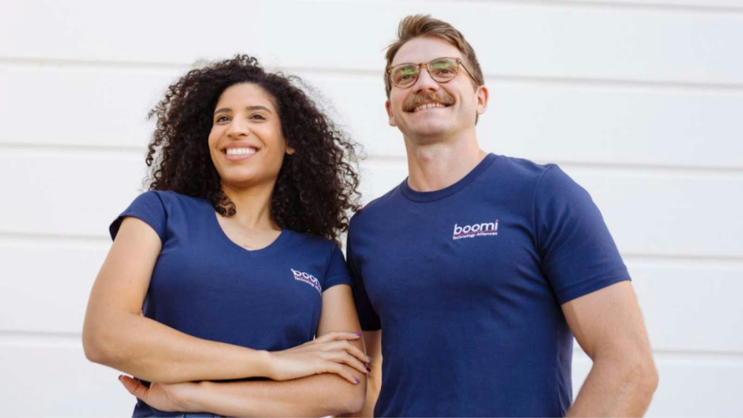 man and women wearing matching navy shirts but the women is wearing a women's cut and the man is wearing an unisex tee