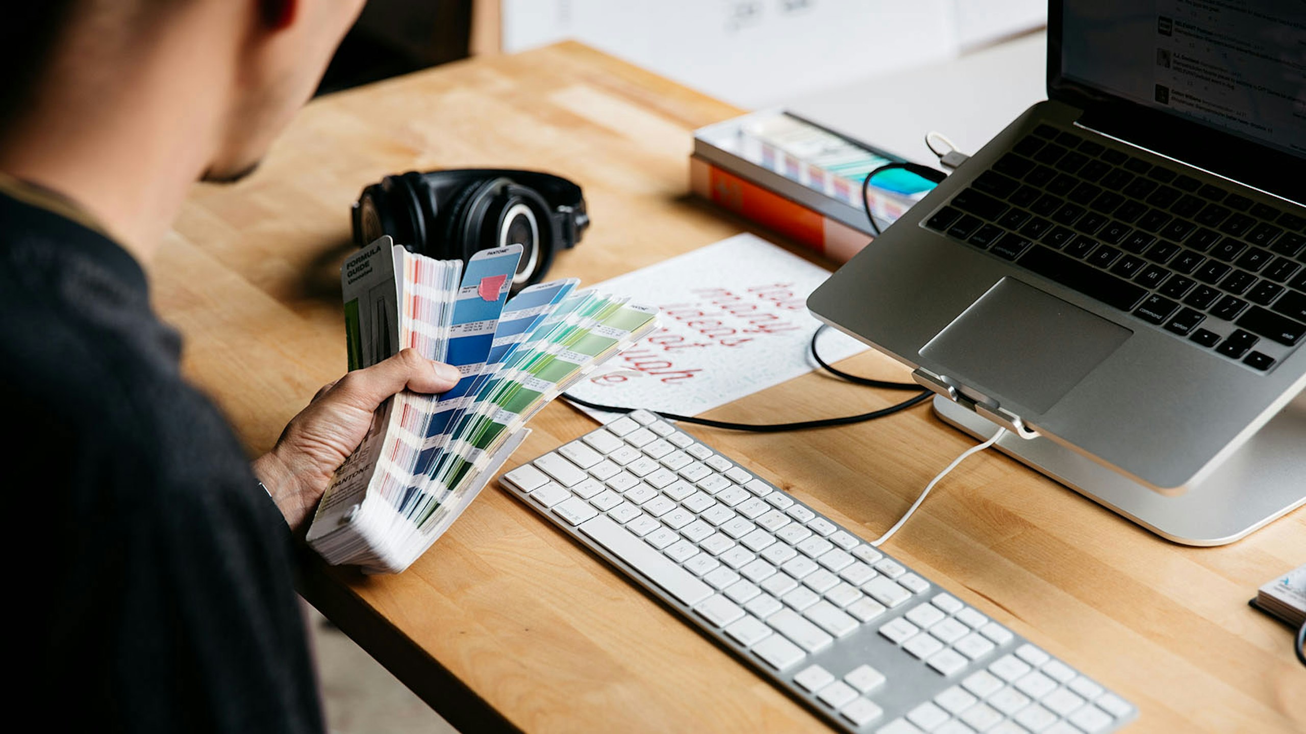 person holding a pantone book