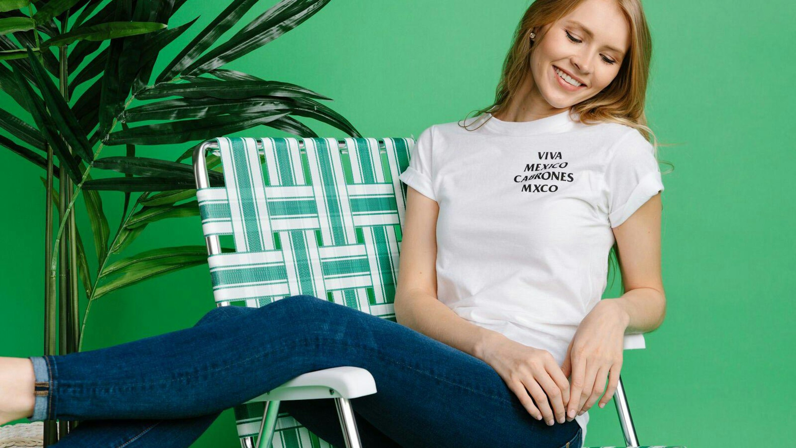 women wearing a white shirt in front of a green background