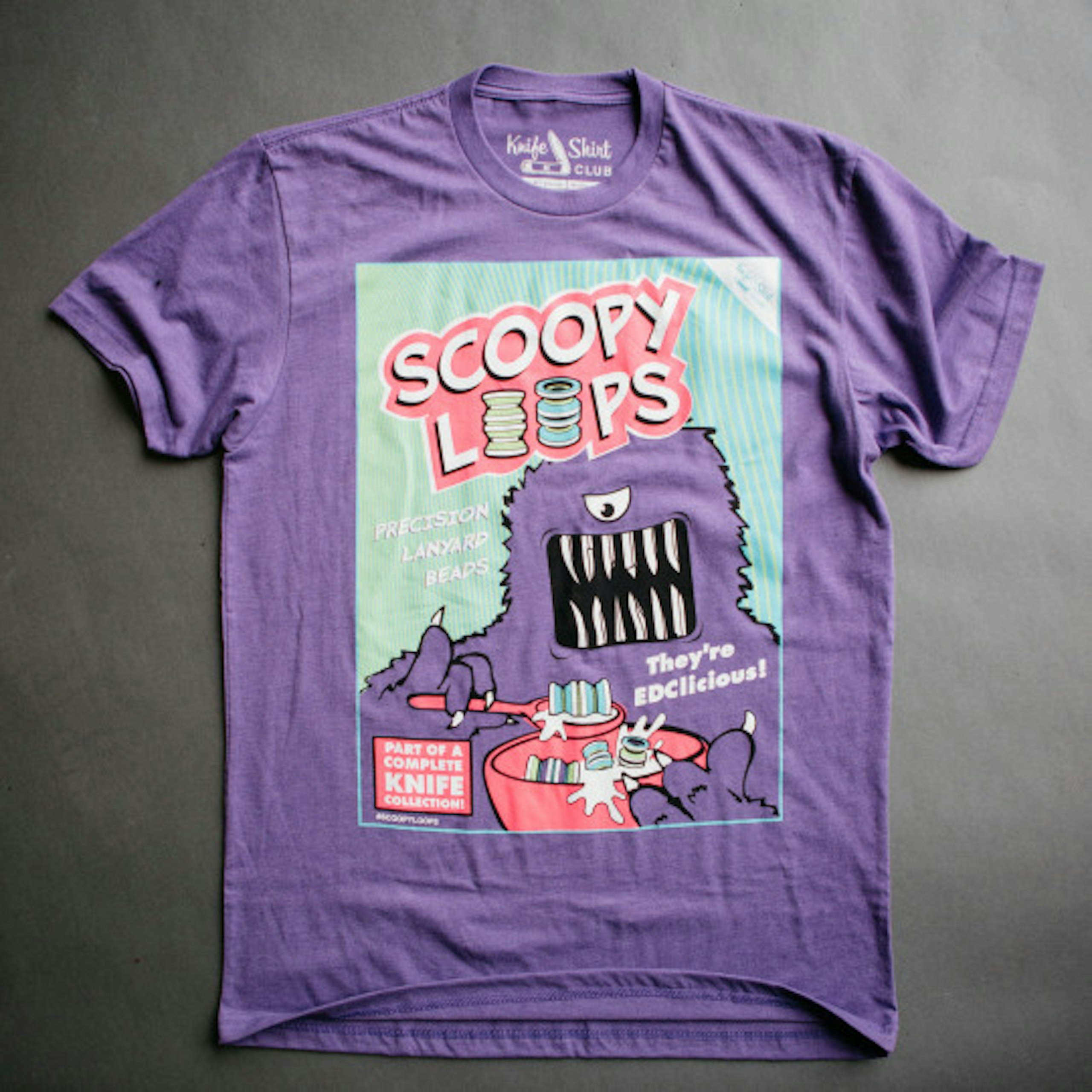 purple t-shirt with a comic like design on the front
