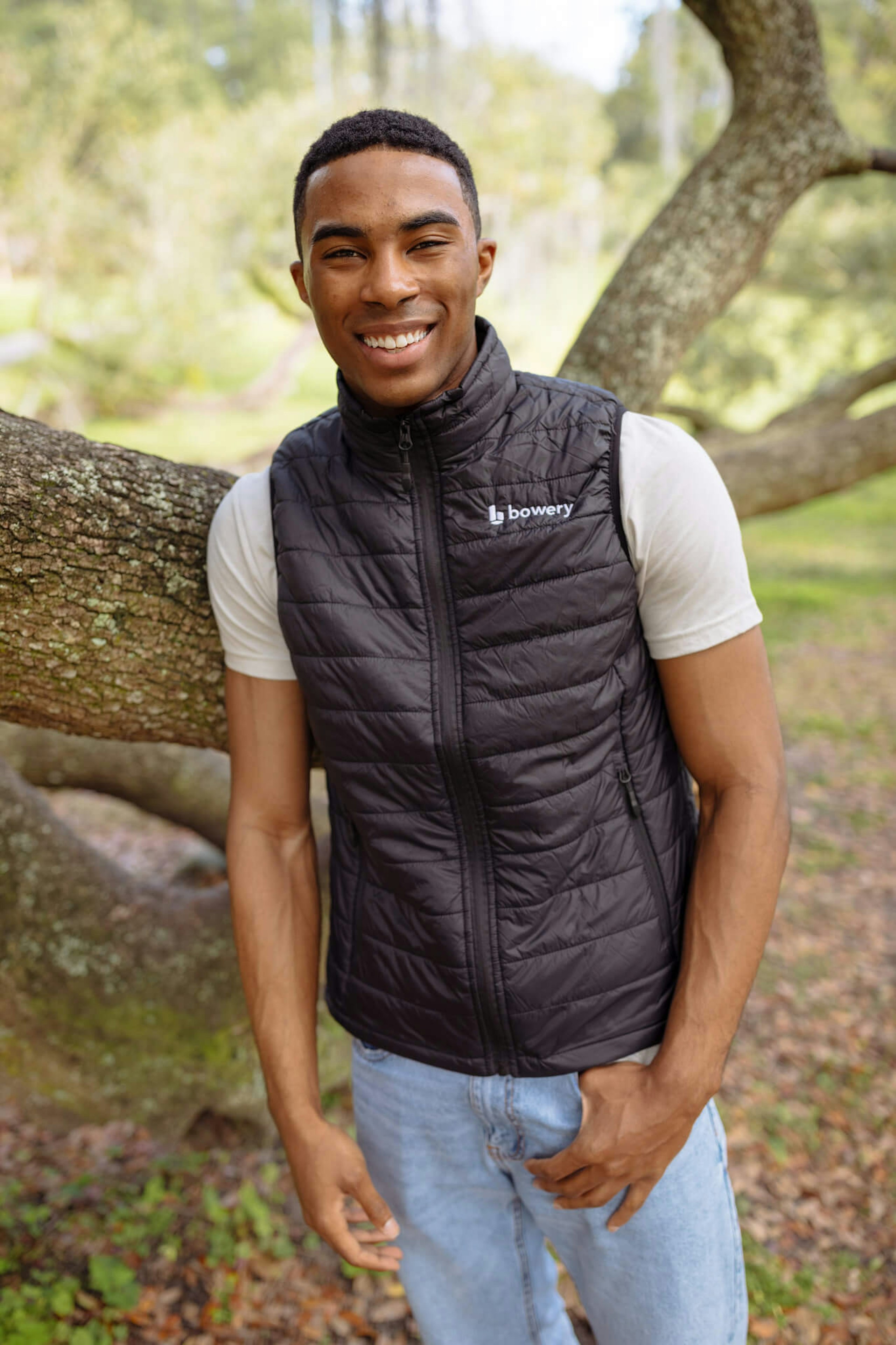 a man wearing a black vest with Bowery embroidered on the top right chest