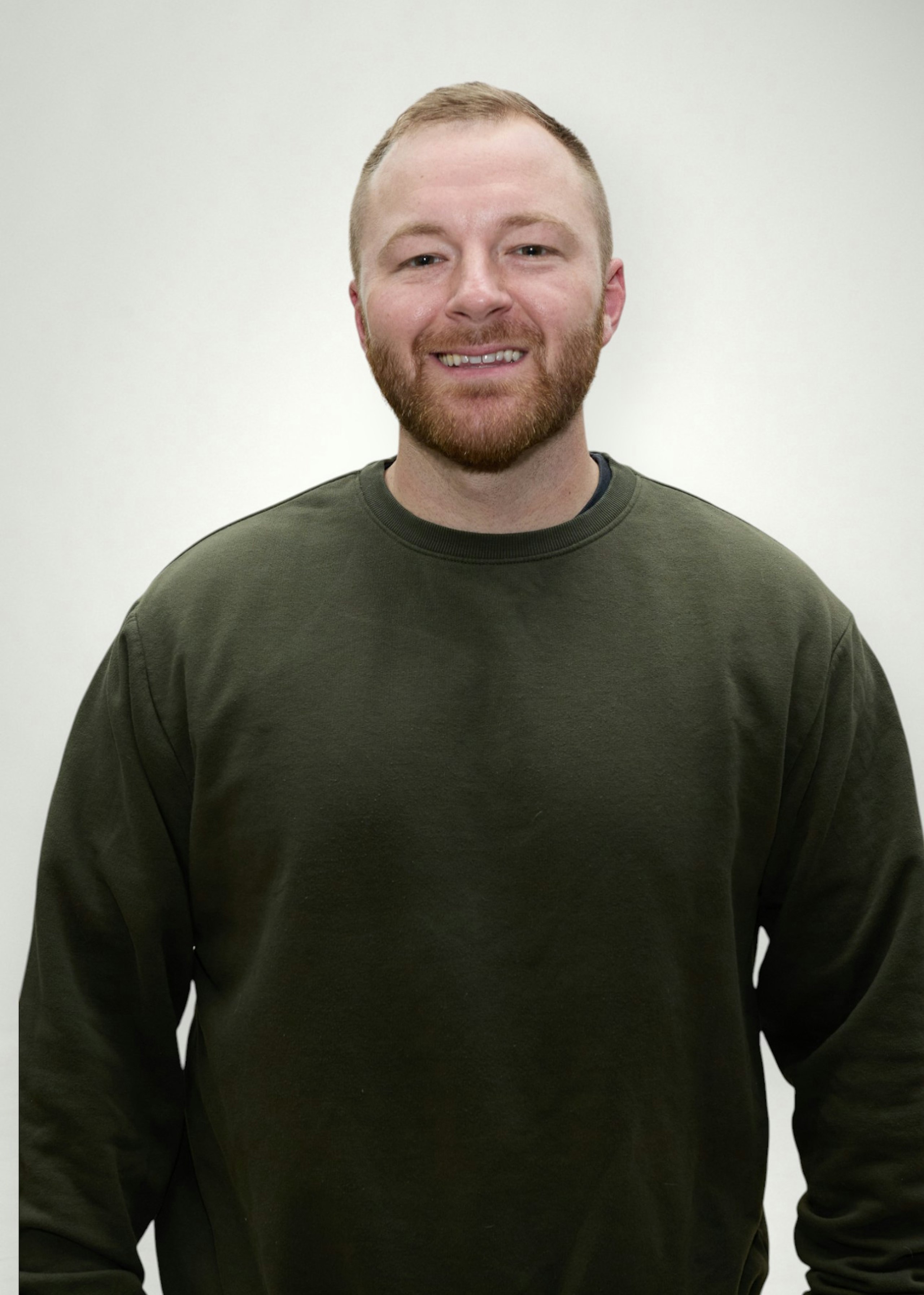 Luke poses in front of white background