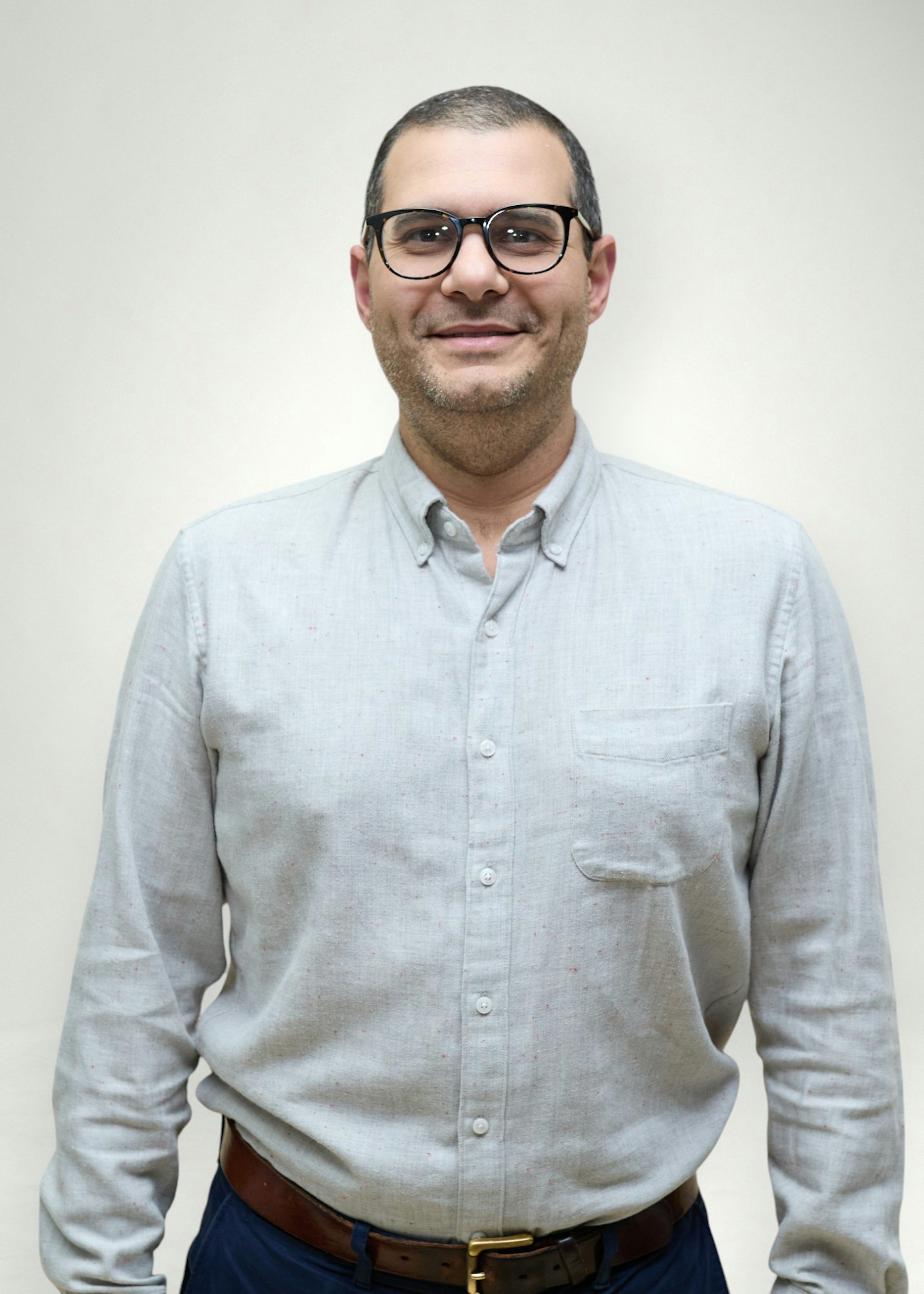 Joey poses in front of white background