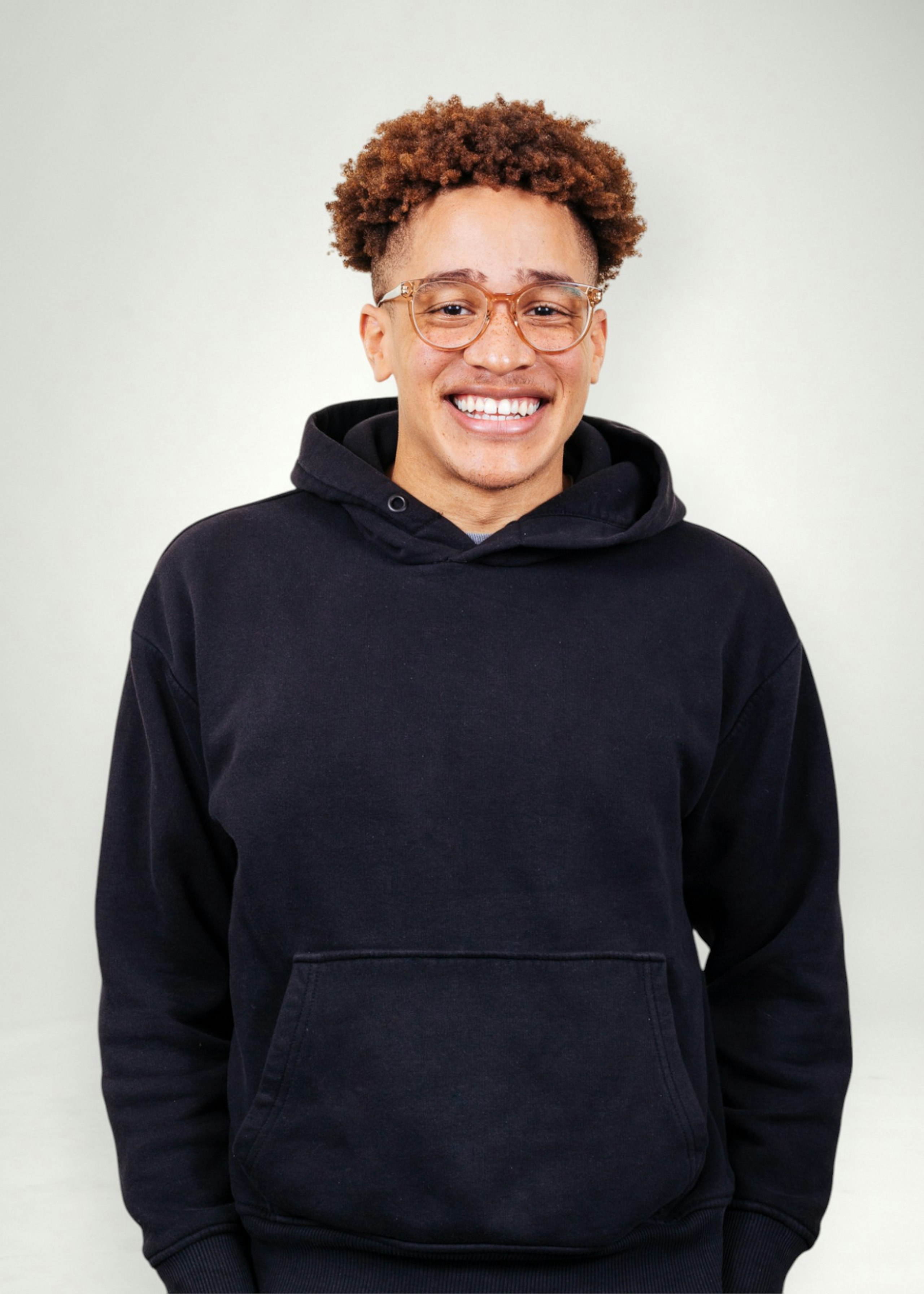 Kai poses in front of white background