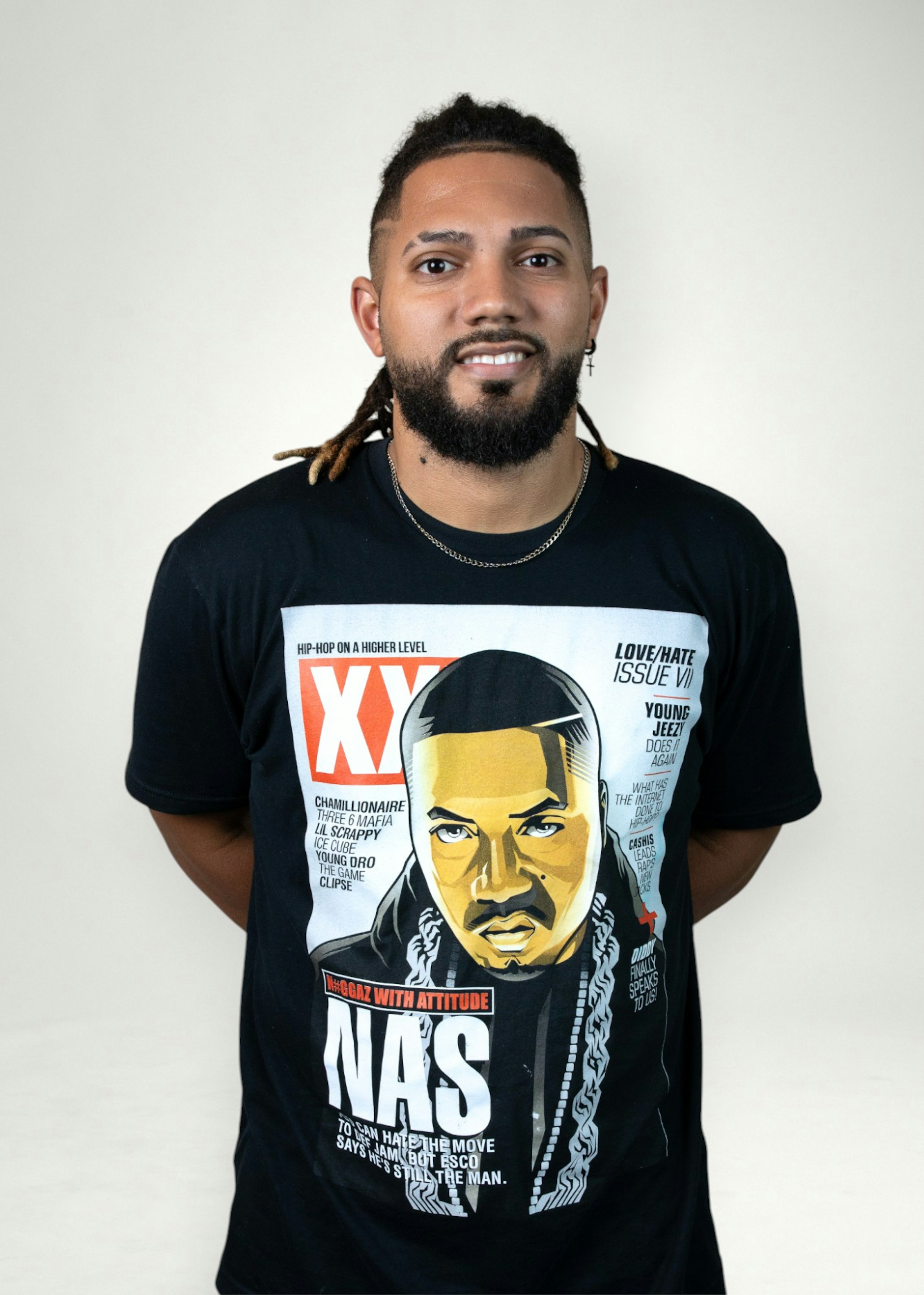 Alex poses in front of white background
