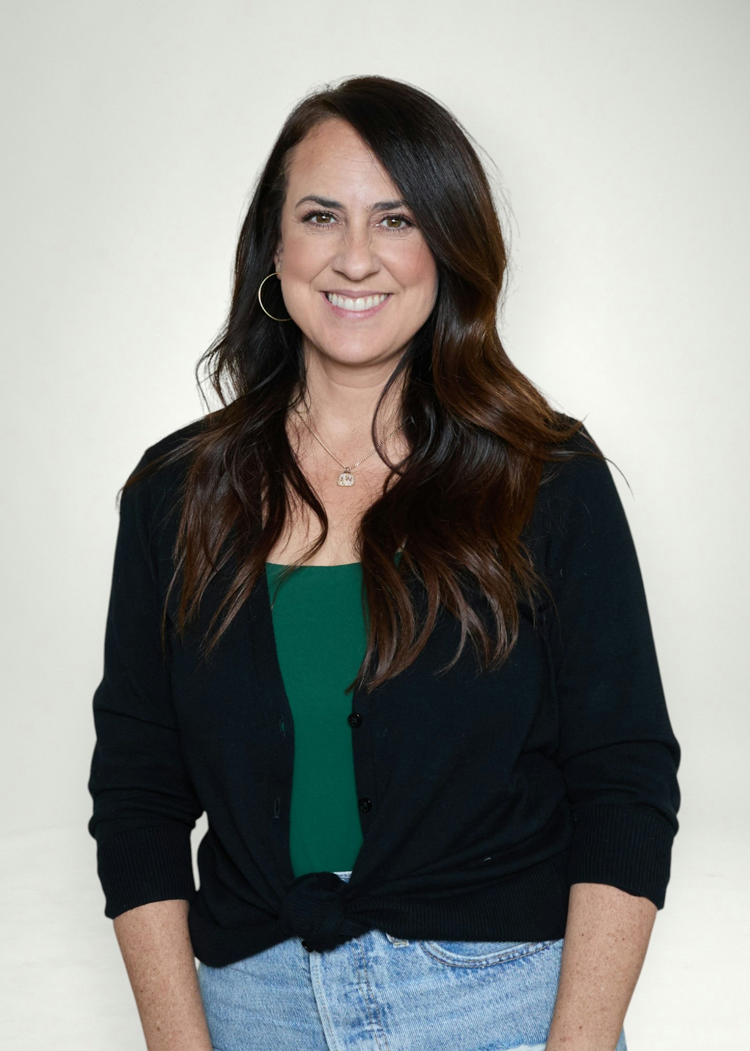 Kelsee poses in front of white background