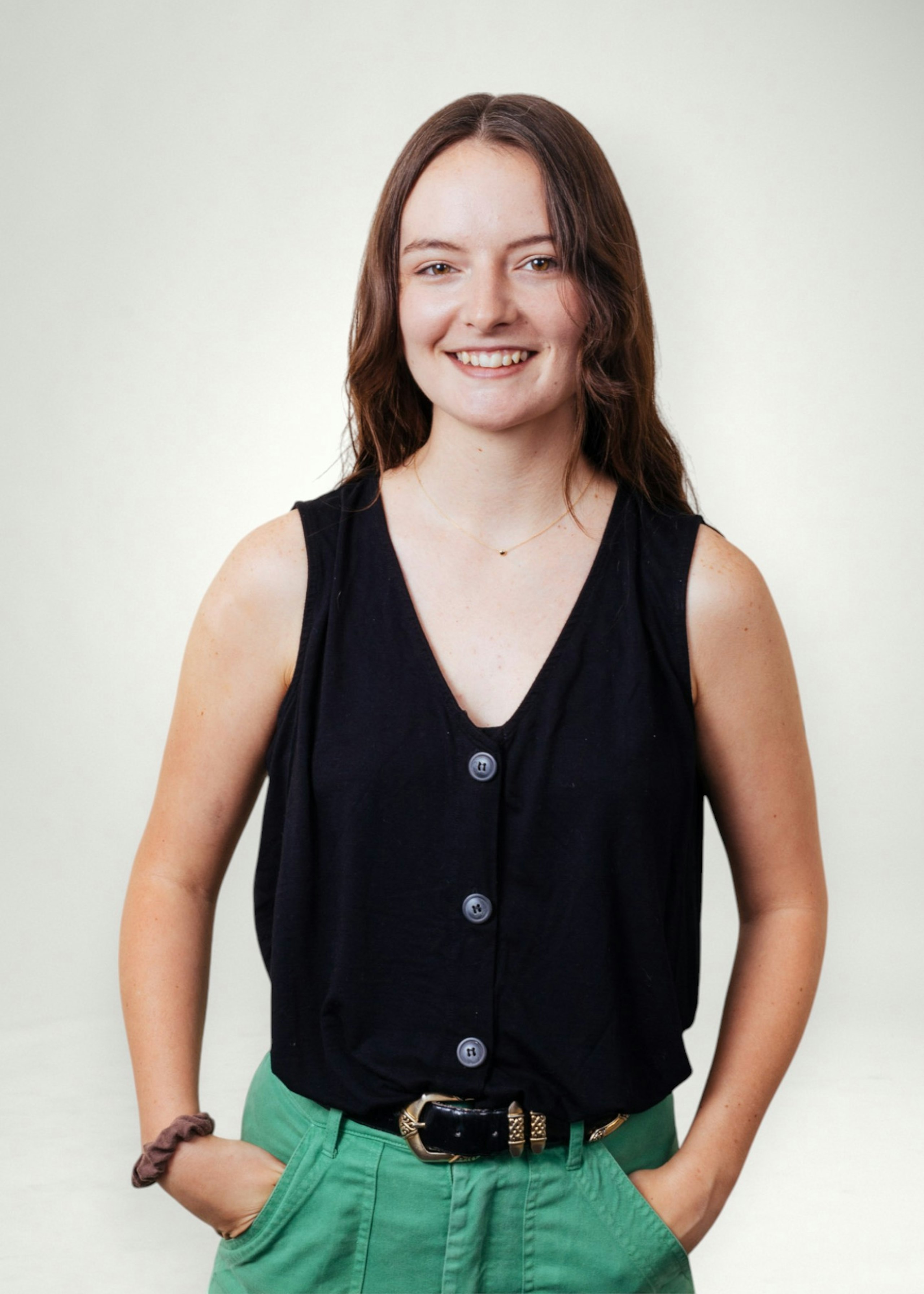 Kristen poses in front of white background