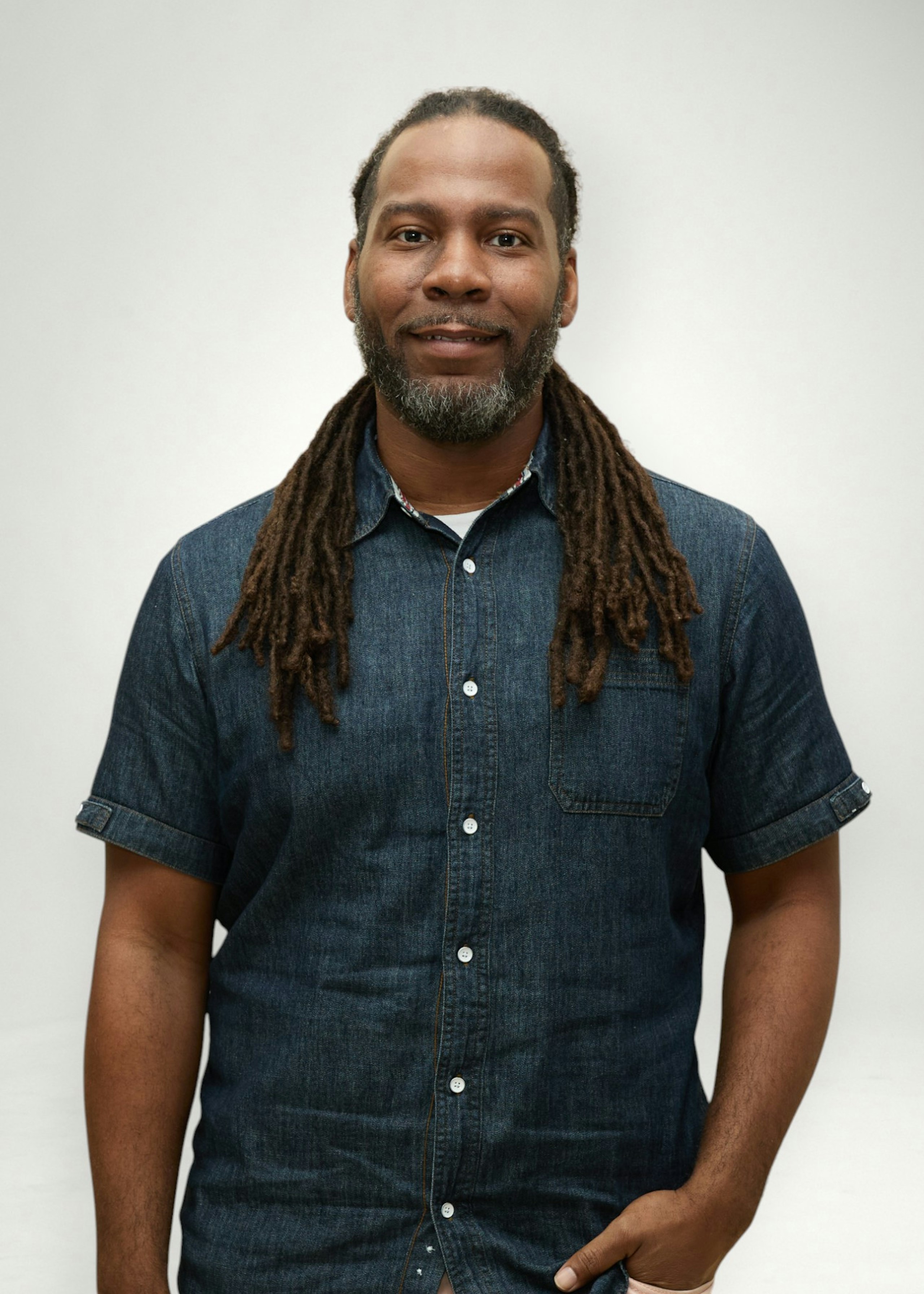 Trey poses in front of white background