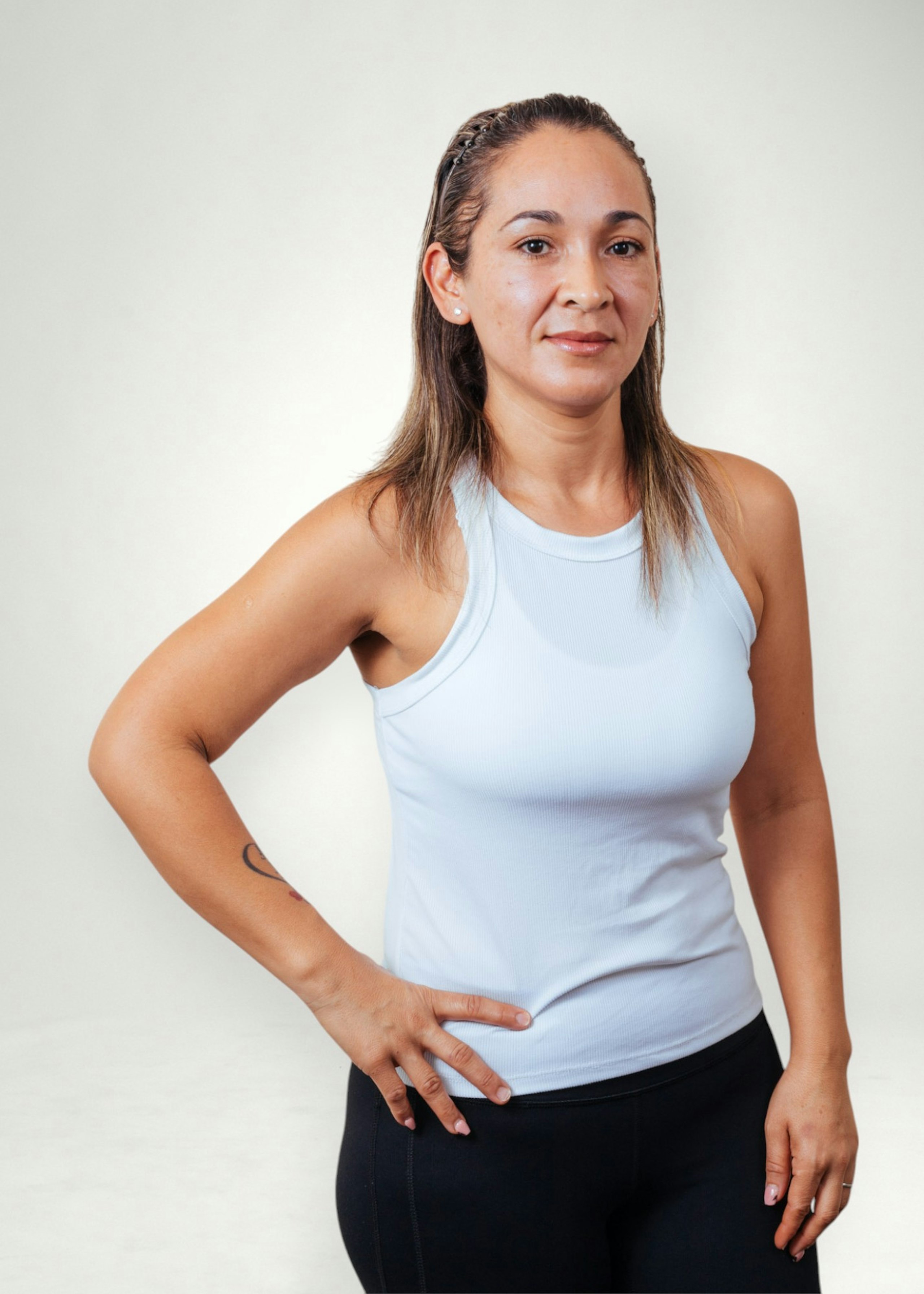 Carmen poses in front of white background