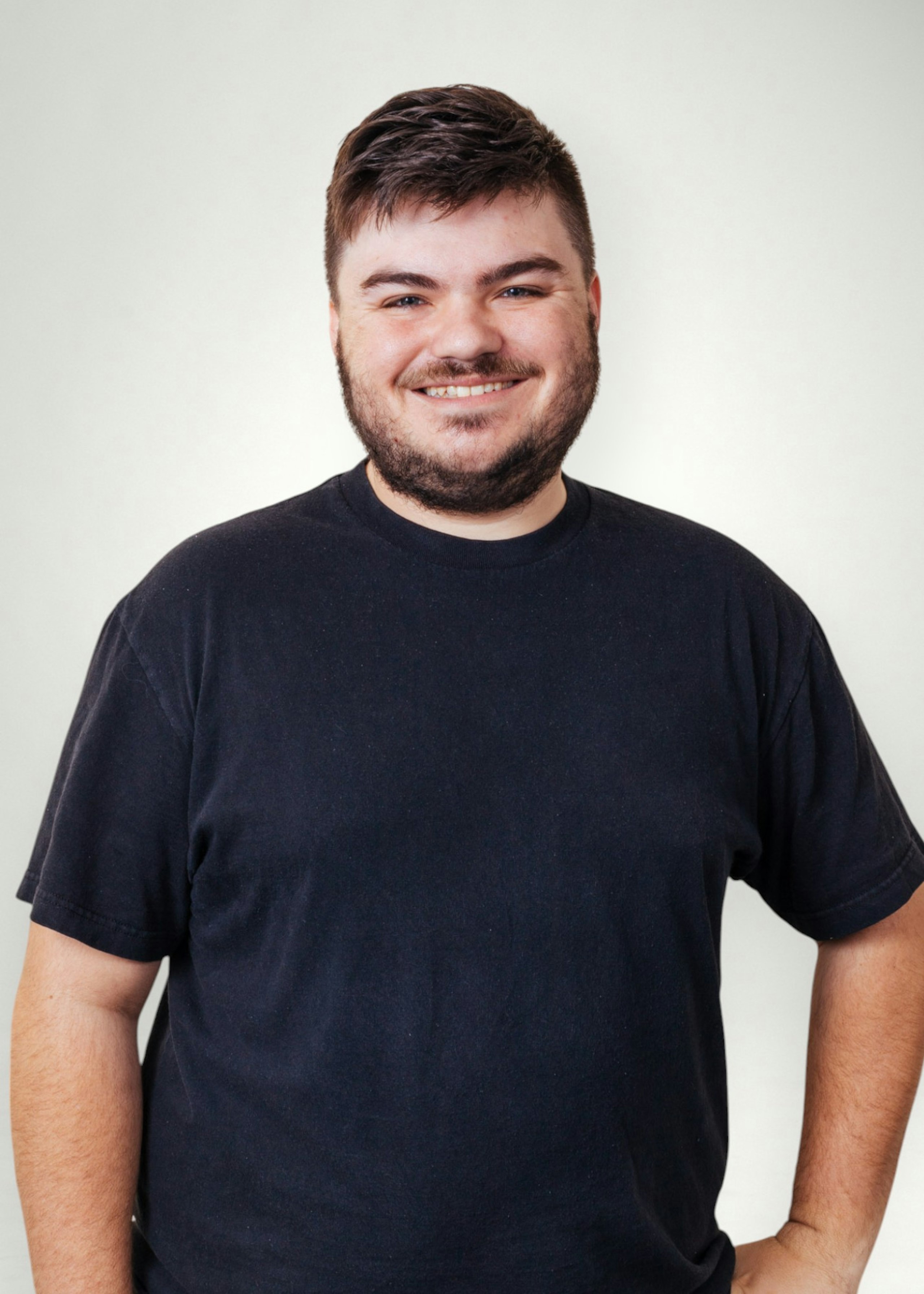 Dalton poses in front of white background