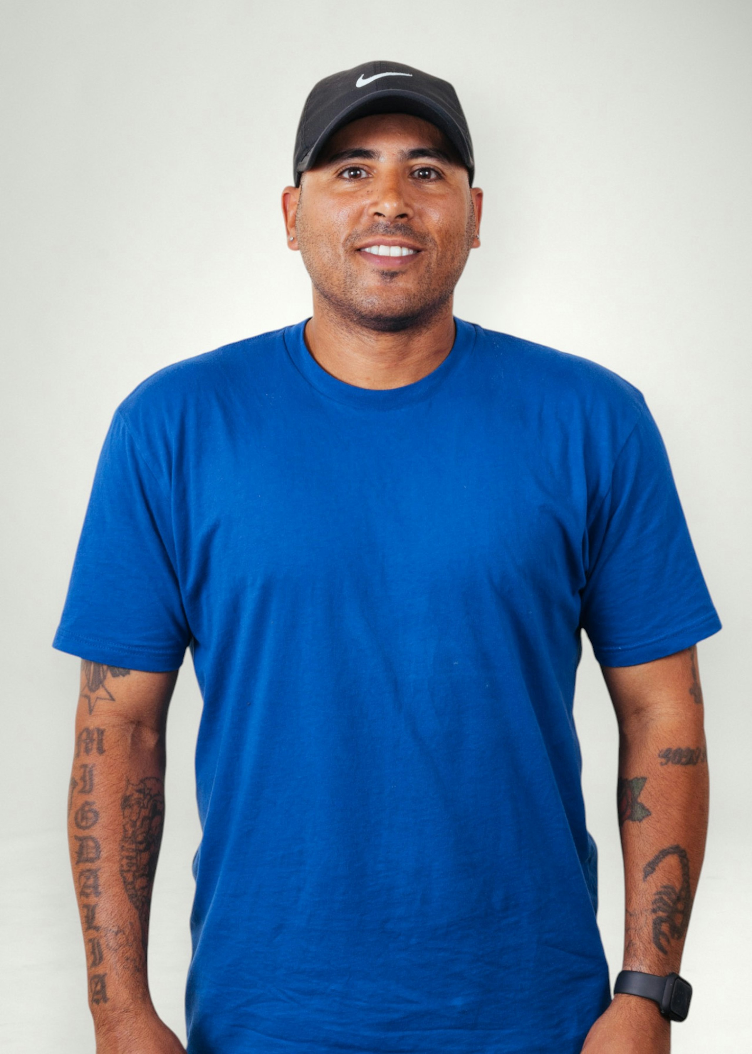 Jose poses in front of white background