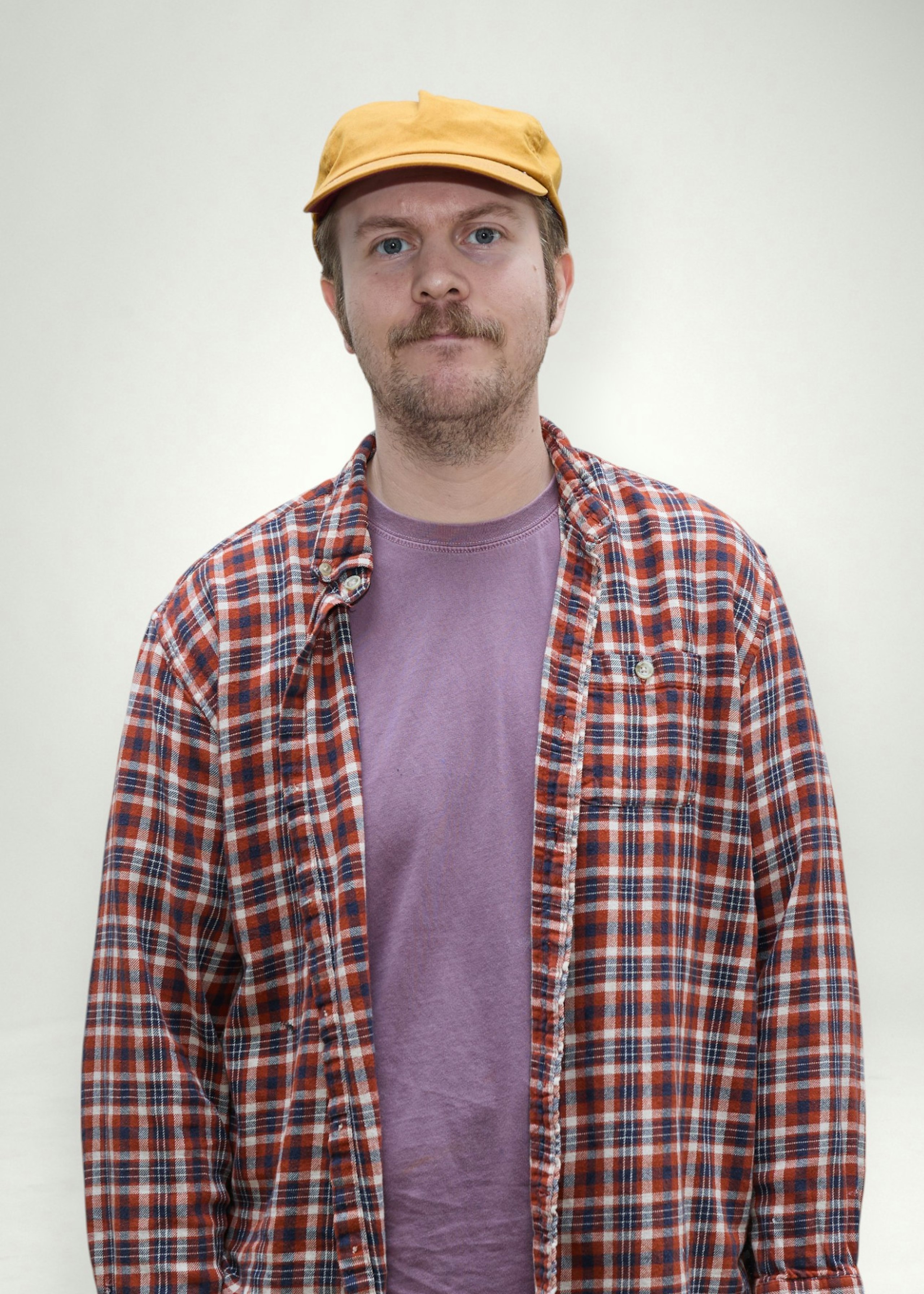 Matt poses in front of white background