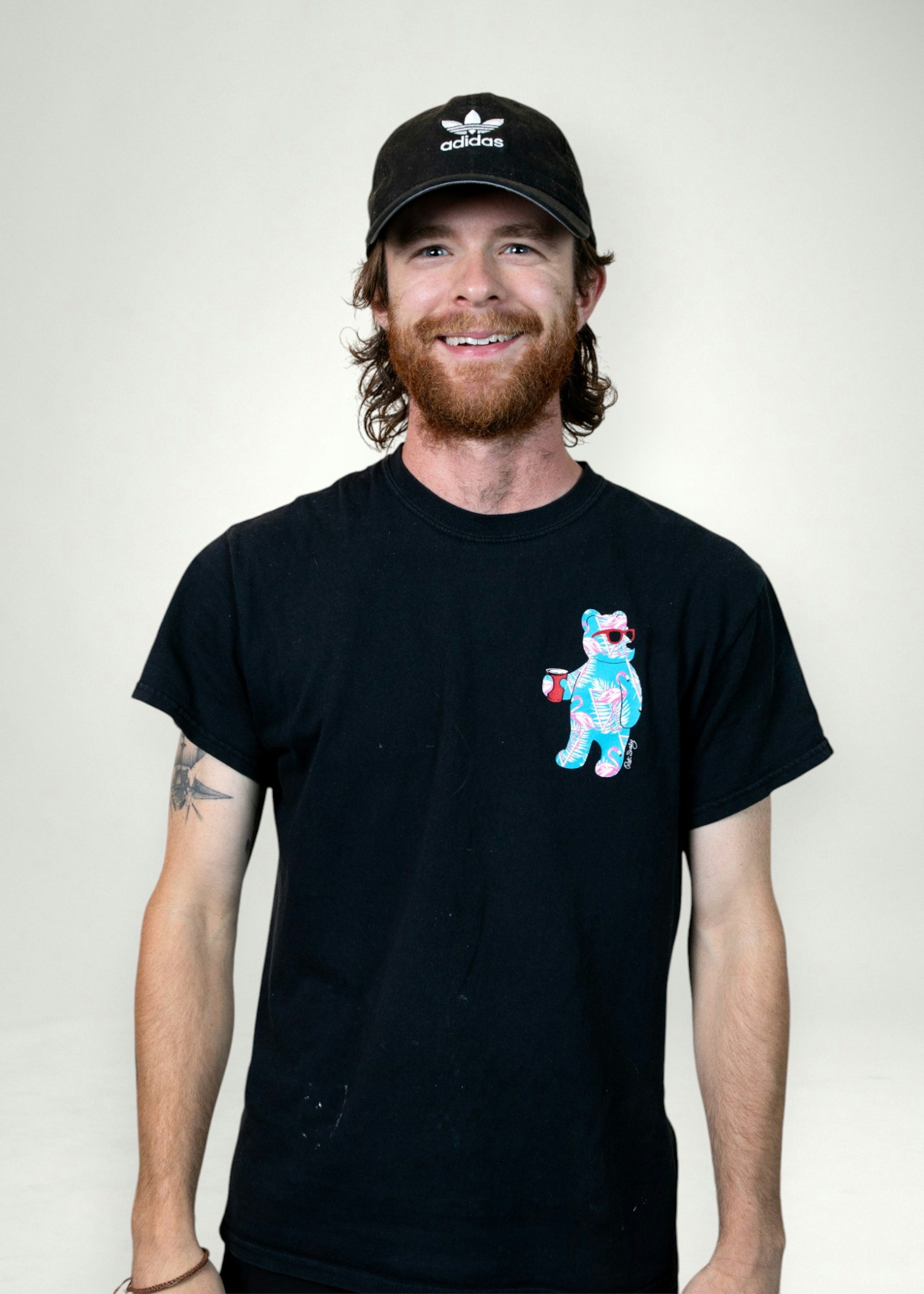 Tyler poses in front of white background