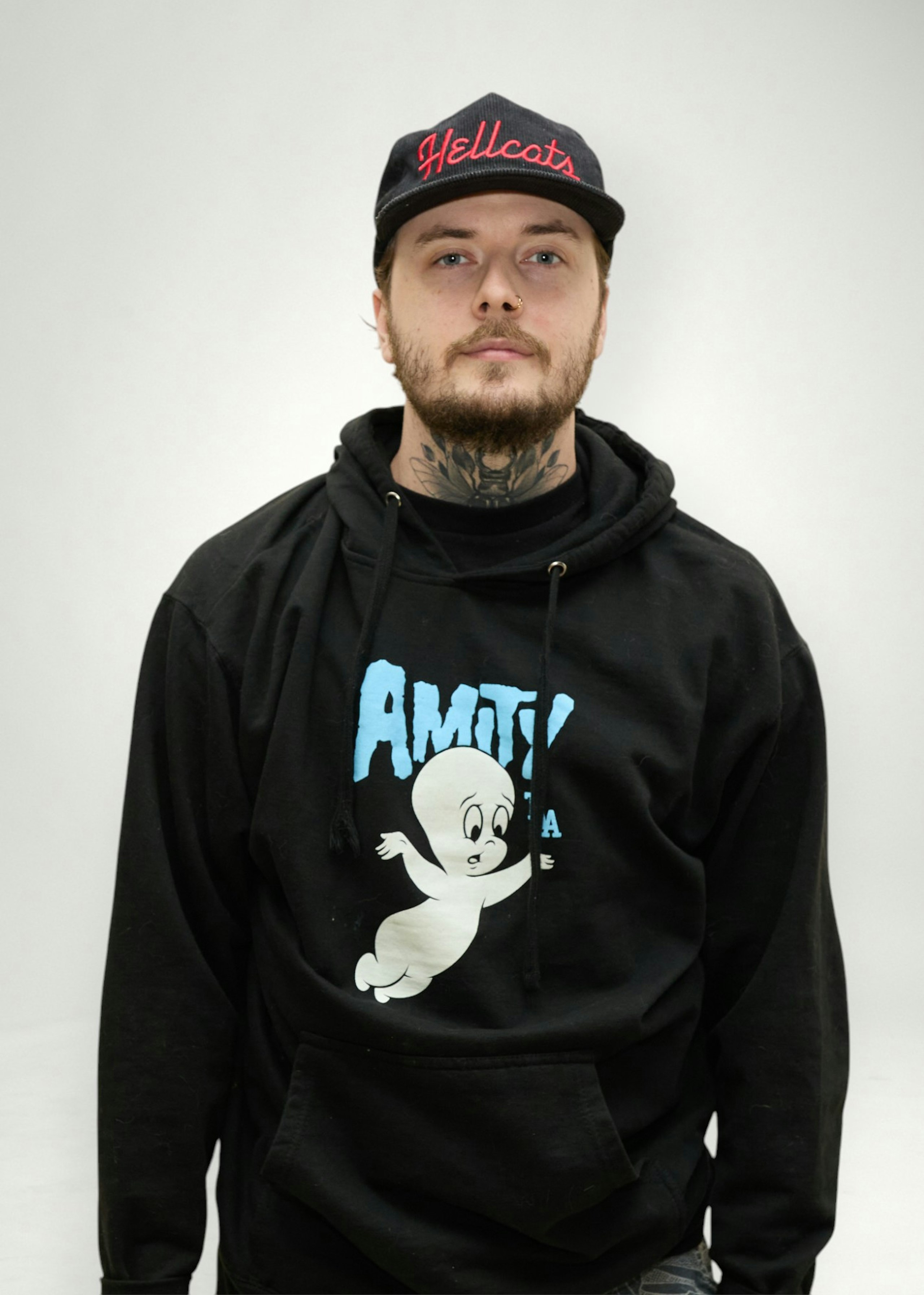 Chris poses in front of white background