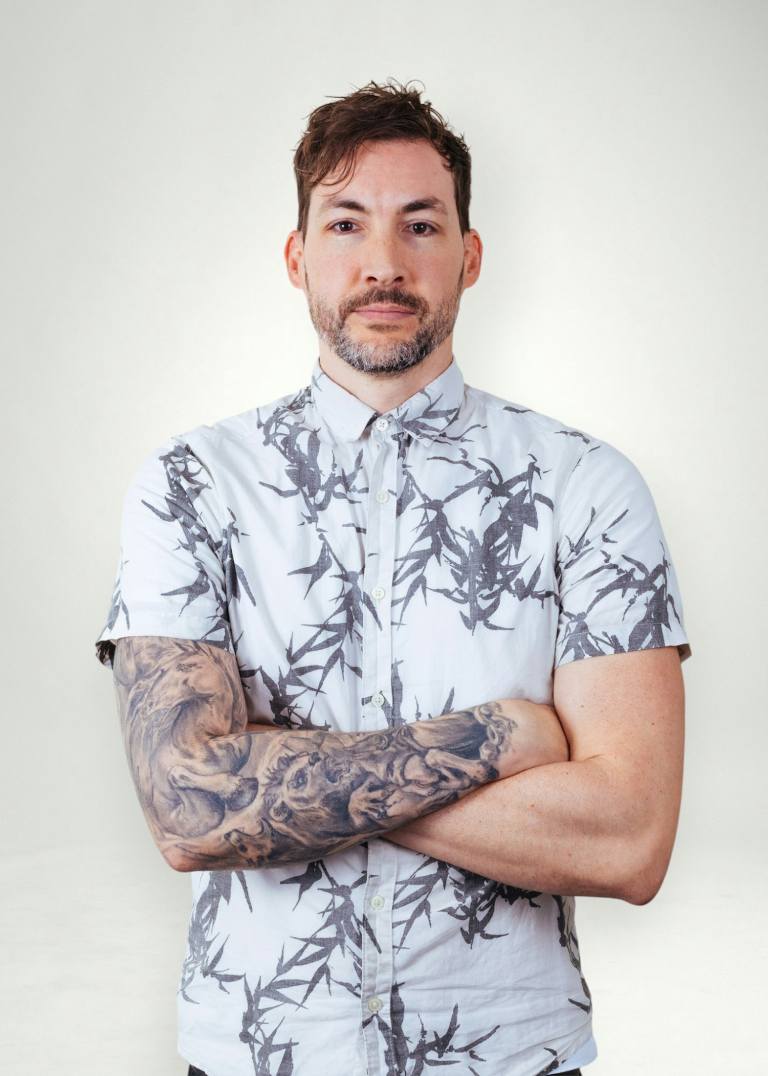 John poses in front of white background