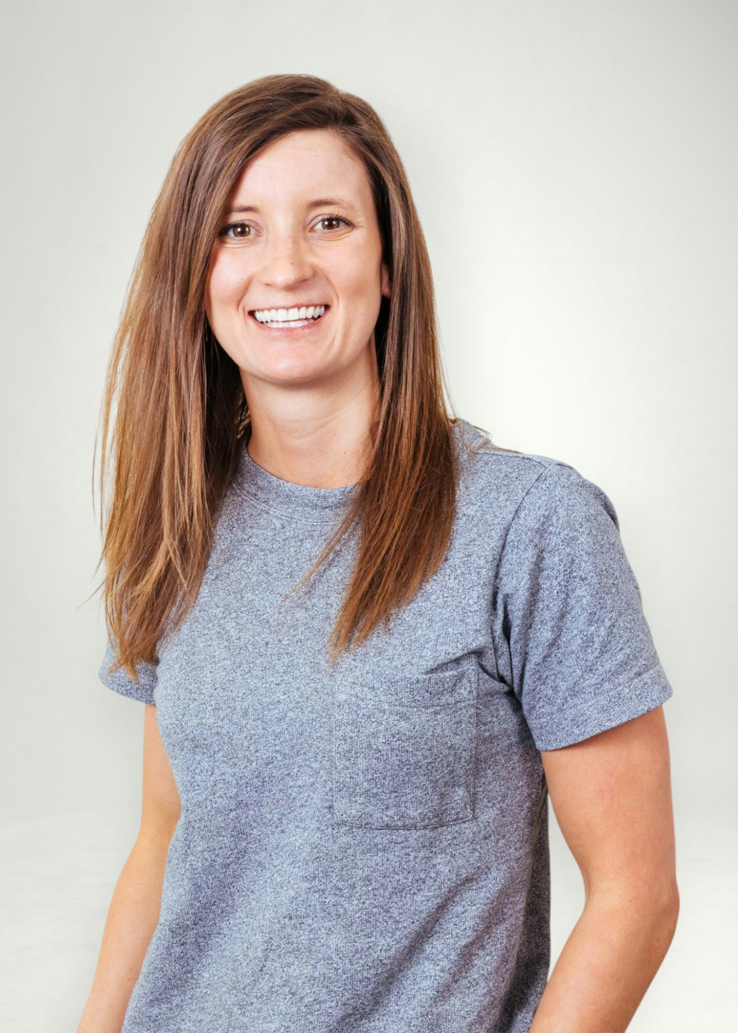 Emily poses in front of white background