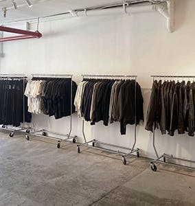 dark clothing on rolling racks