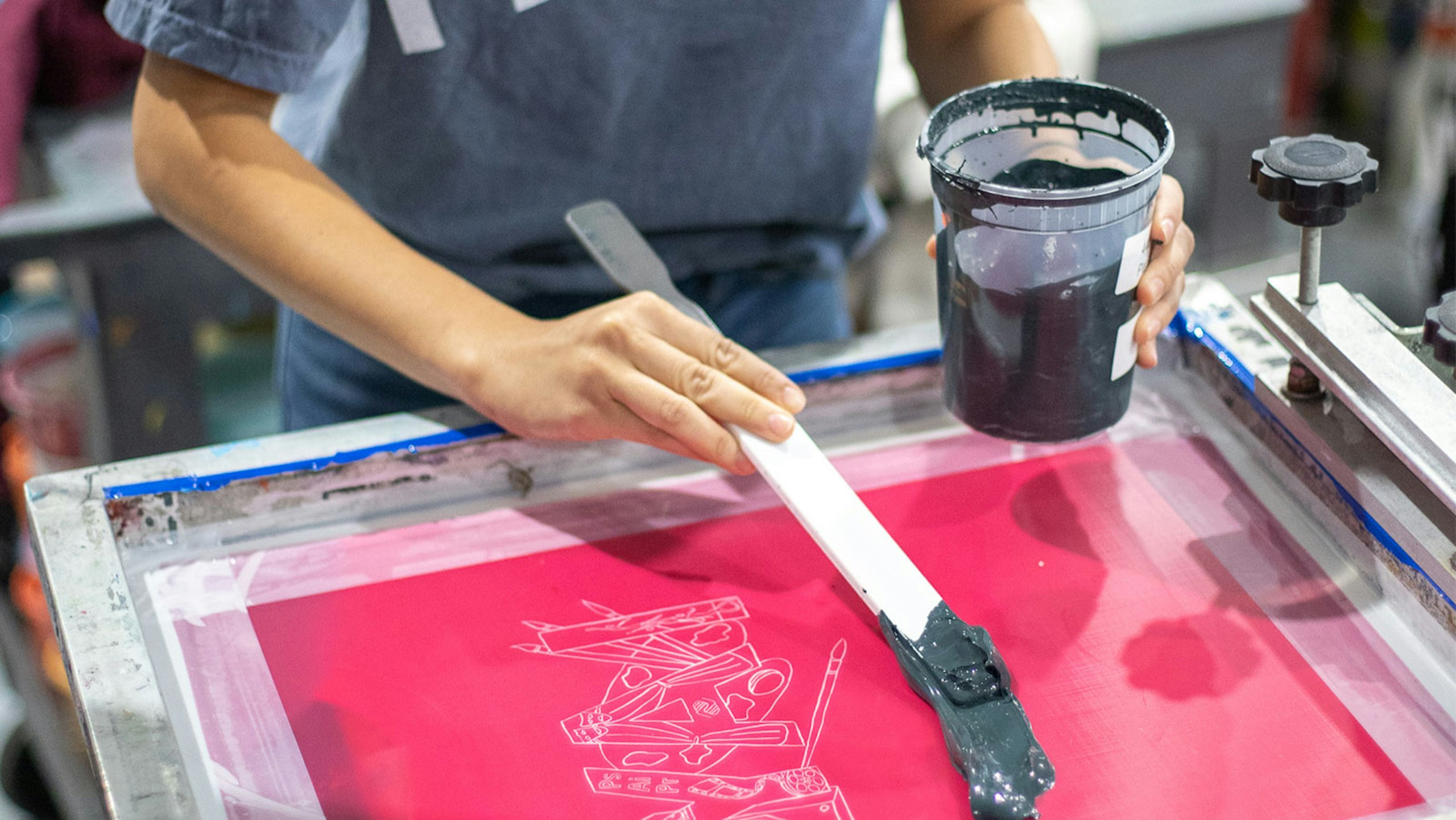 someone adding ink to a screen