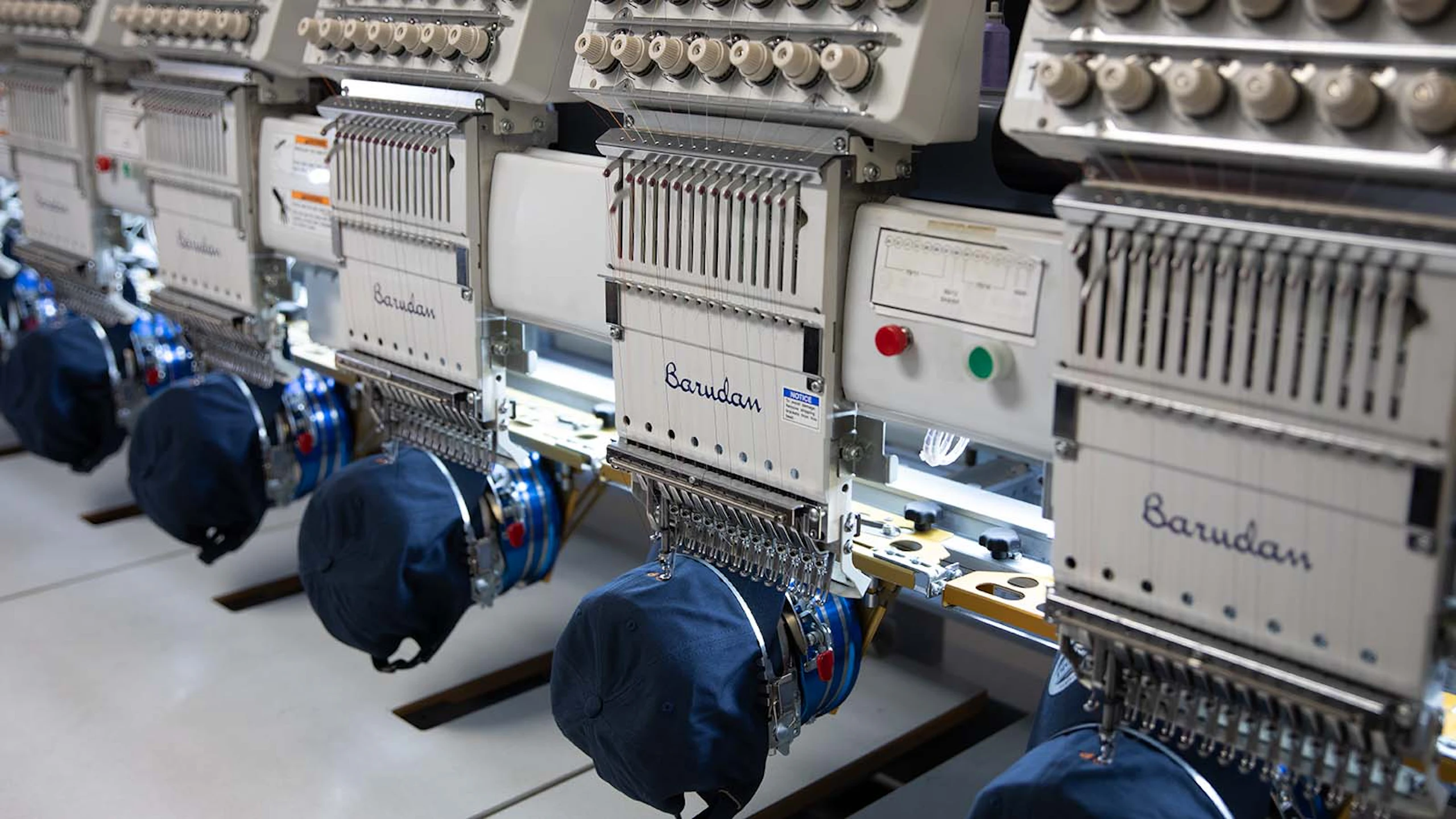 hats being embroidered by embroidery machines