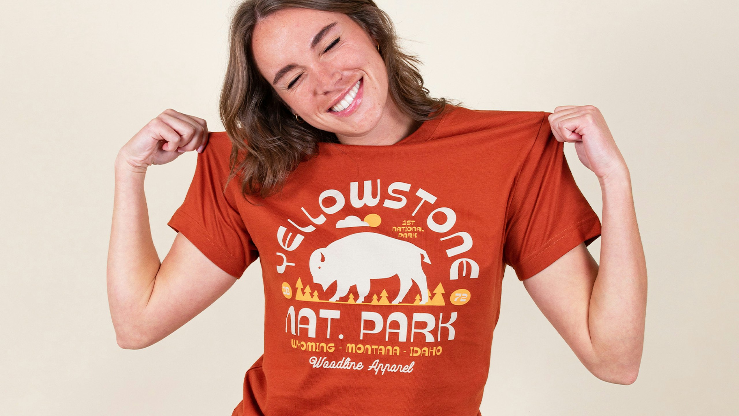 women wearing an orange t-shirt with the words Yellowstone nat. park printed on it with abuffaloo