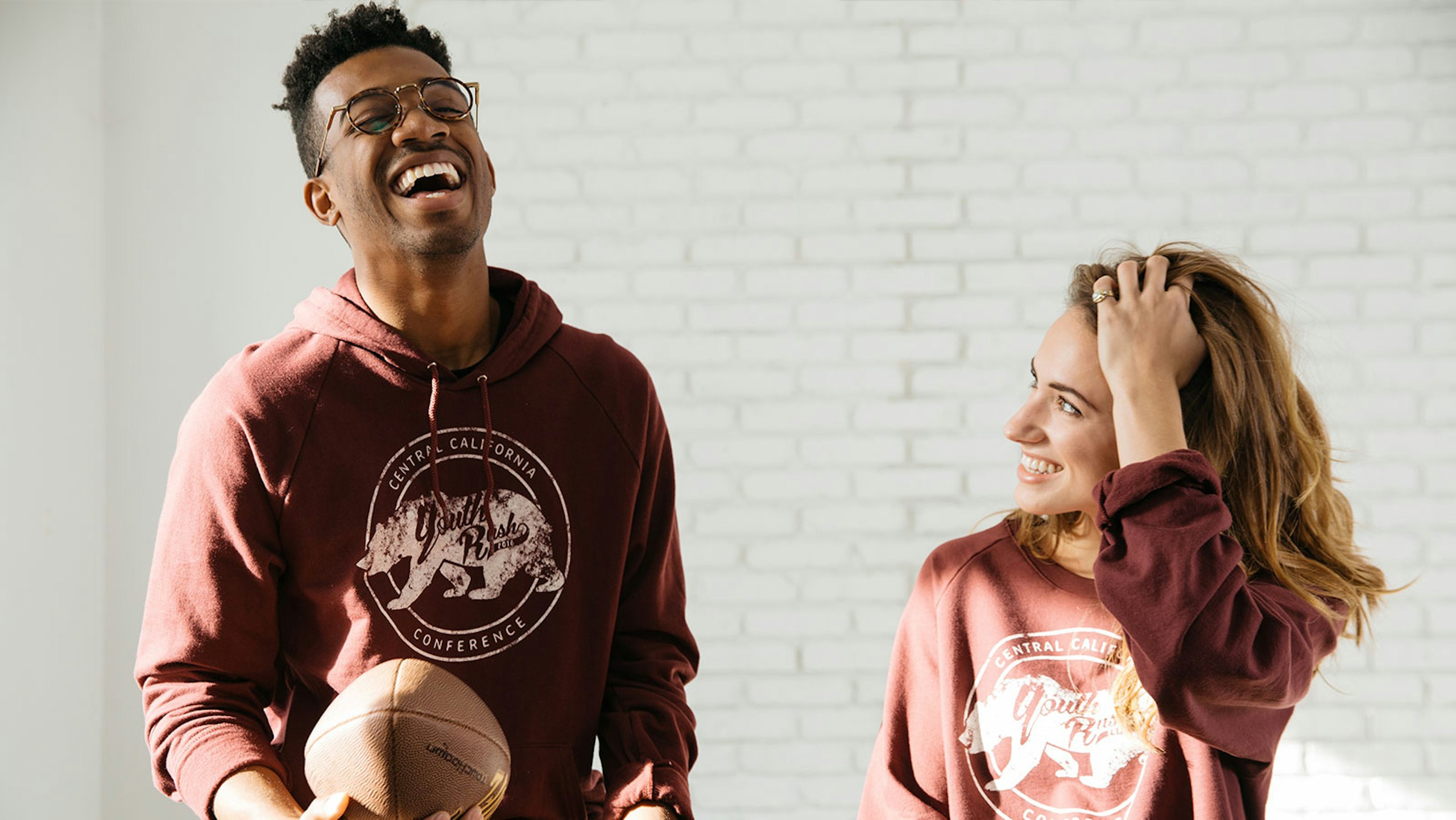 man and women wearing a red hoodie