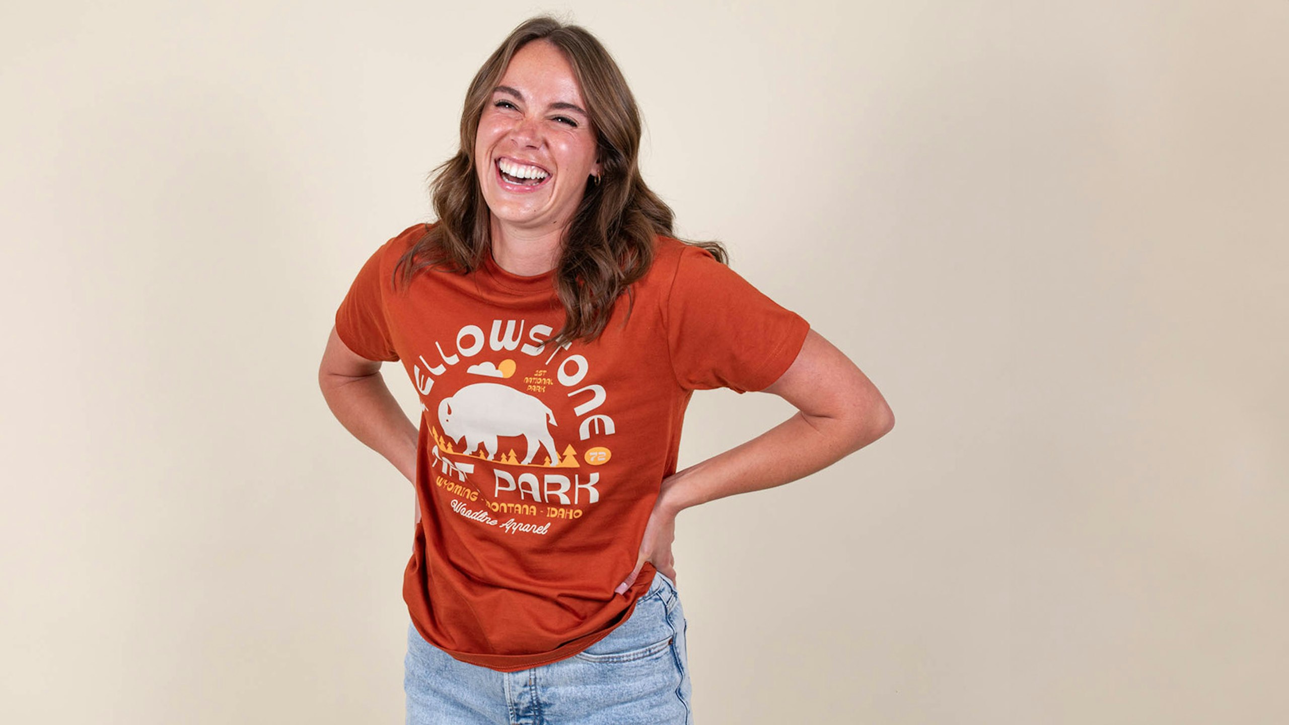 women wearing an orange t-shirt with the words Yellowstone nat. park printed on it with abuffaloo