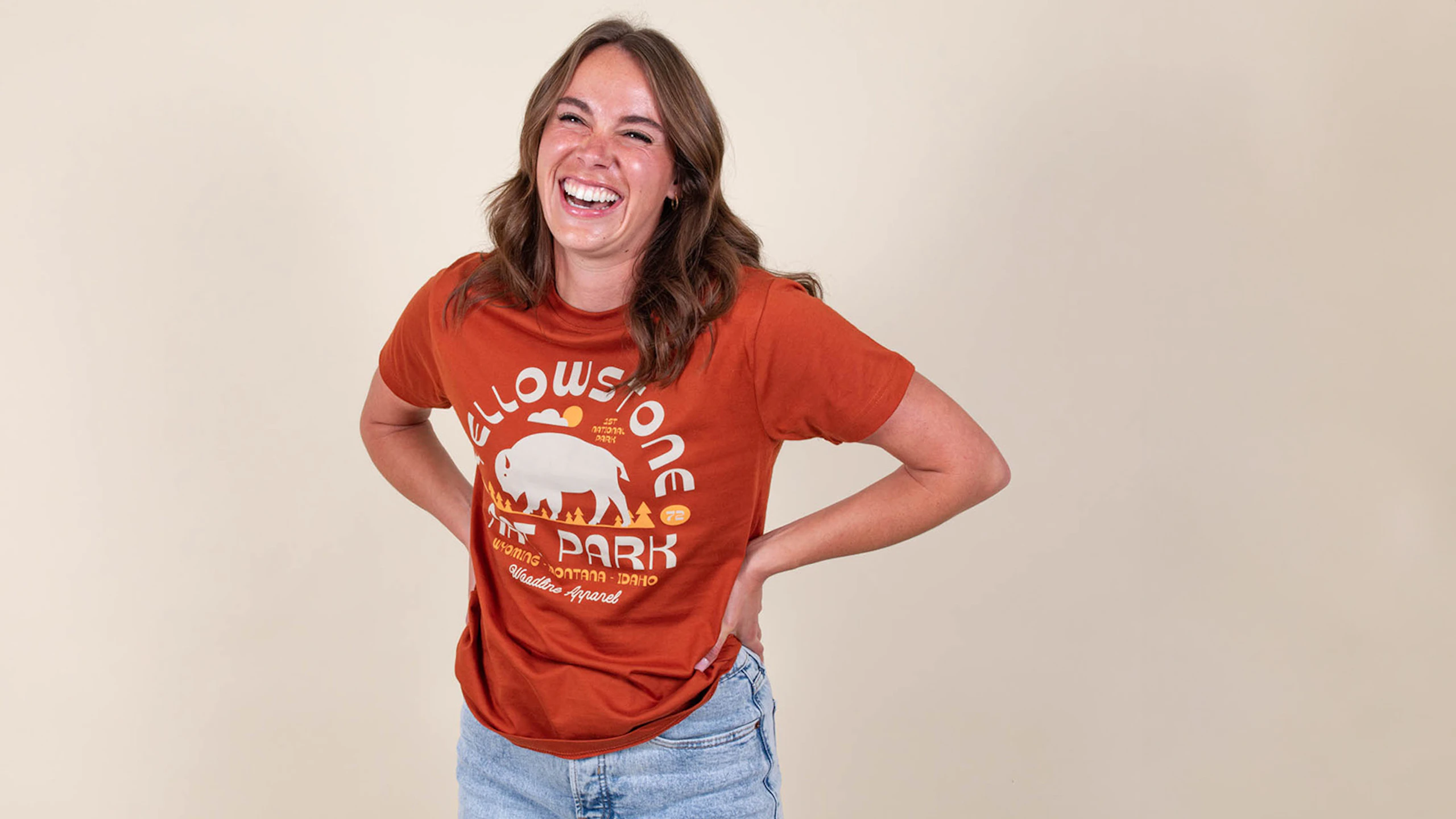 women wearing an orange t-shirt with the words Yellowstone nat. park printed on it with abuffaloo