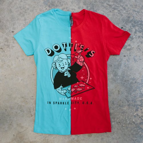 two t-shirts folded in half, one light blue, the other red